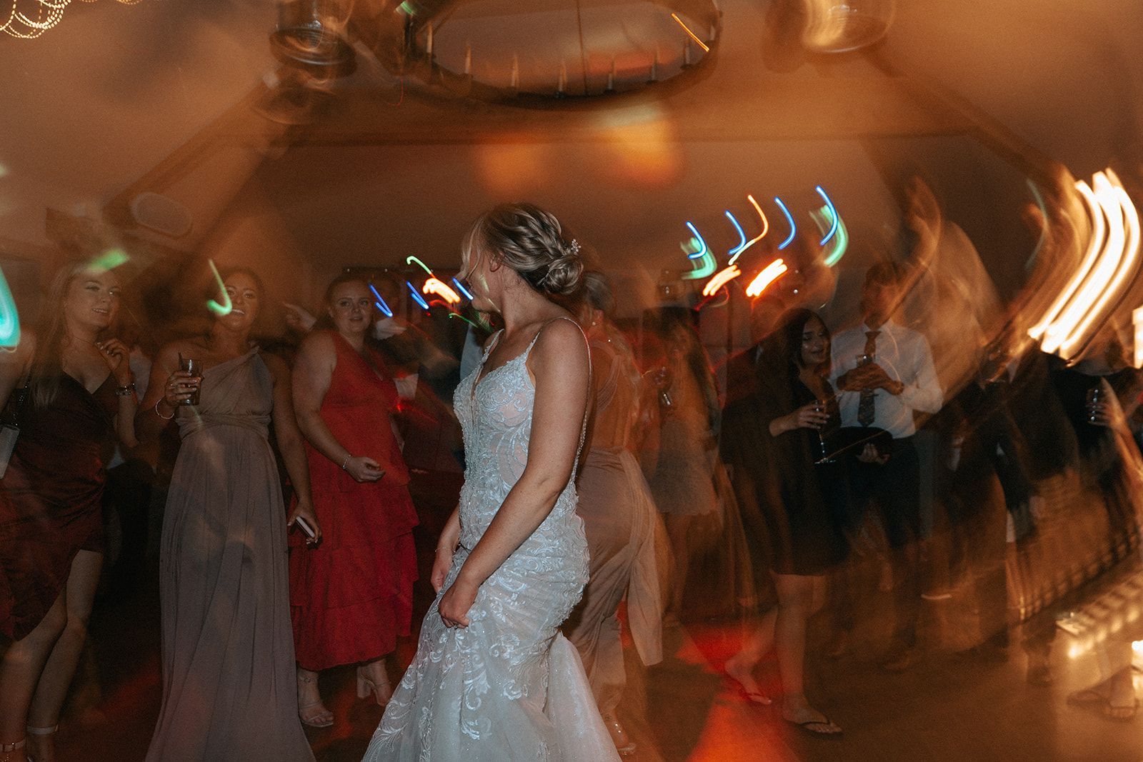 A blurry picture of a bride and groom dancing at a wedding reception.