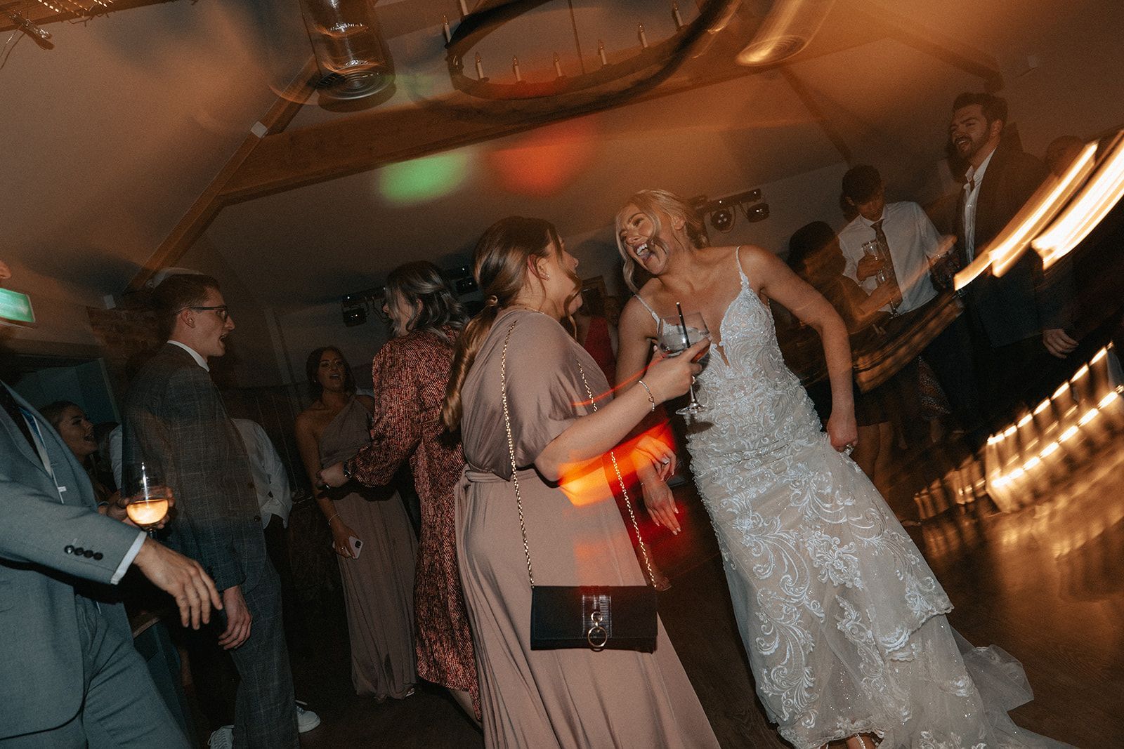 A bride and groom are dancing at a wedding reception.