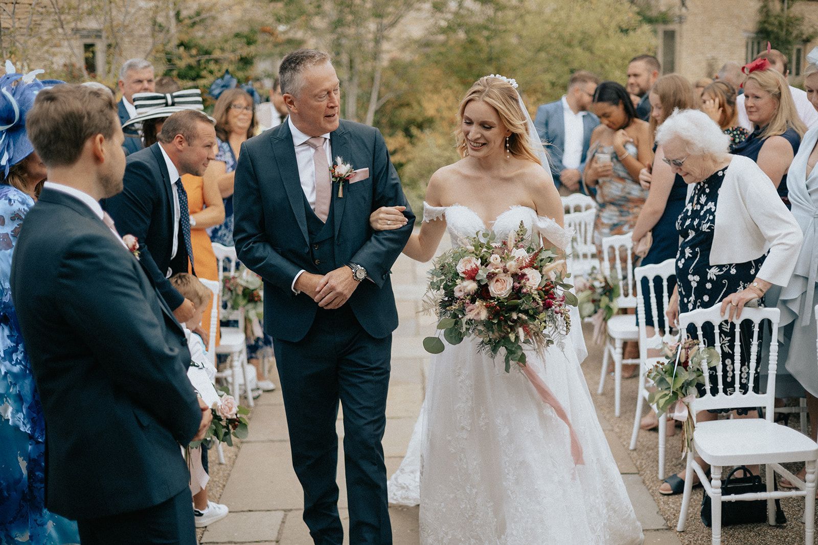 A bride and groom are walking down the aisle at their wedding.