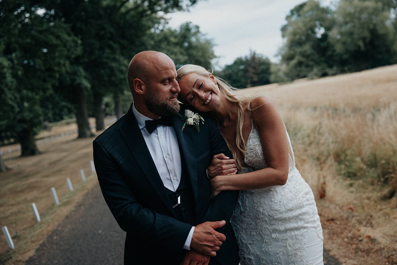 A bride and groom are posing for a picture on their wedding day.