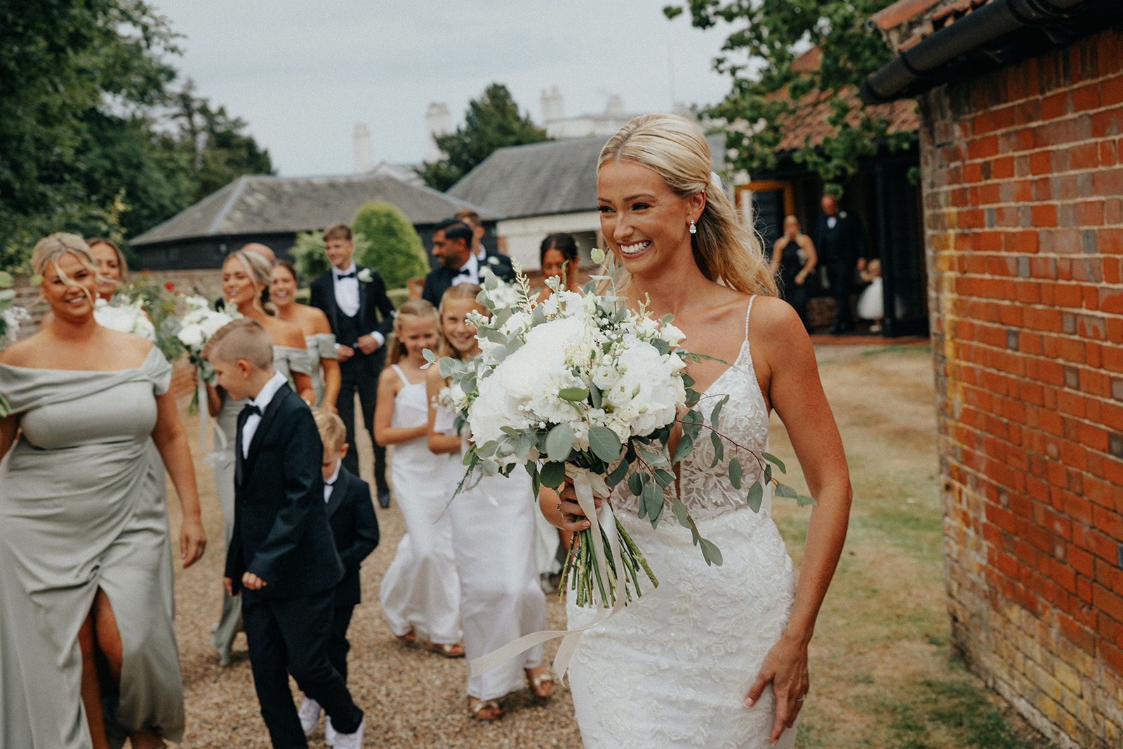 A bride and groom are walking down the aisle with their wedding party.
