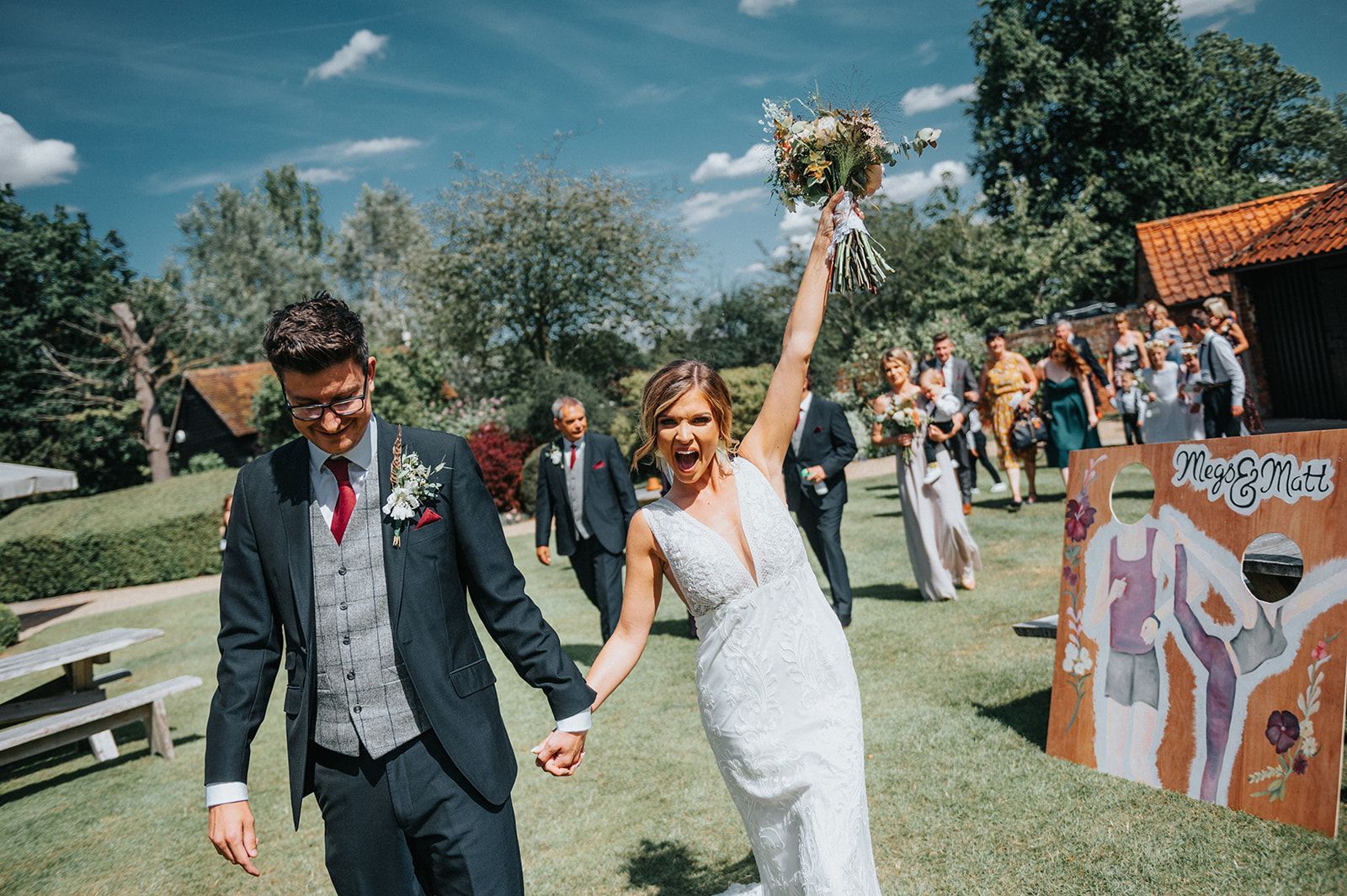 A bride and groom are walking down the aisle at their wedding holding hands.