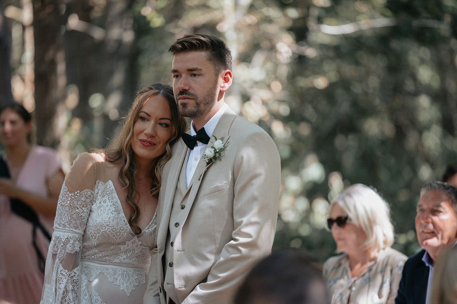 A bride and groom are standing next to each other at their wedding ceremony.