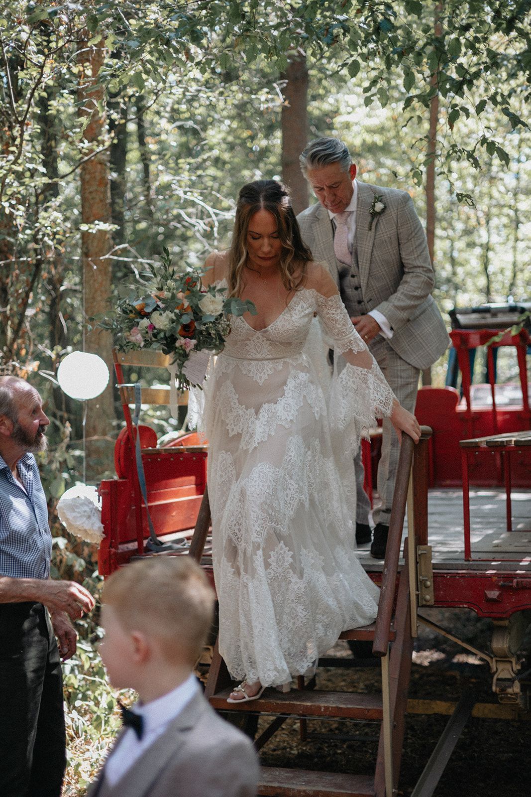 A bride and groom are walking down the stairs at their wedding.