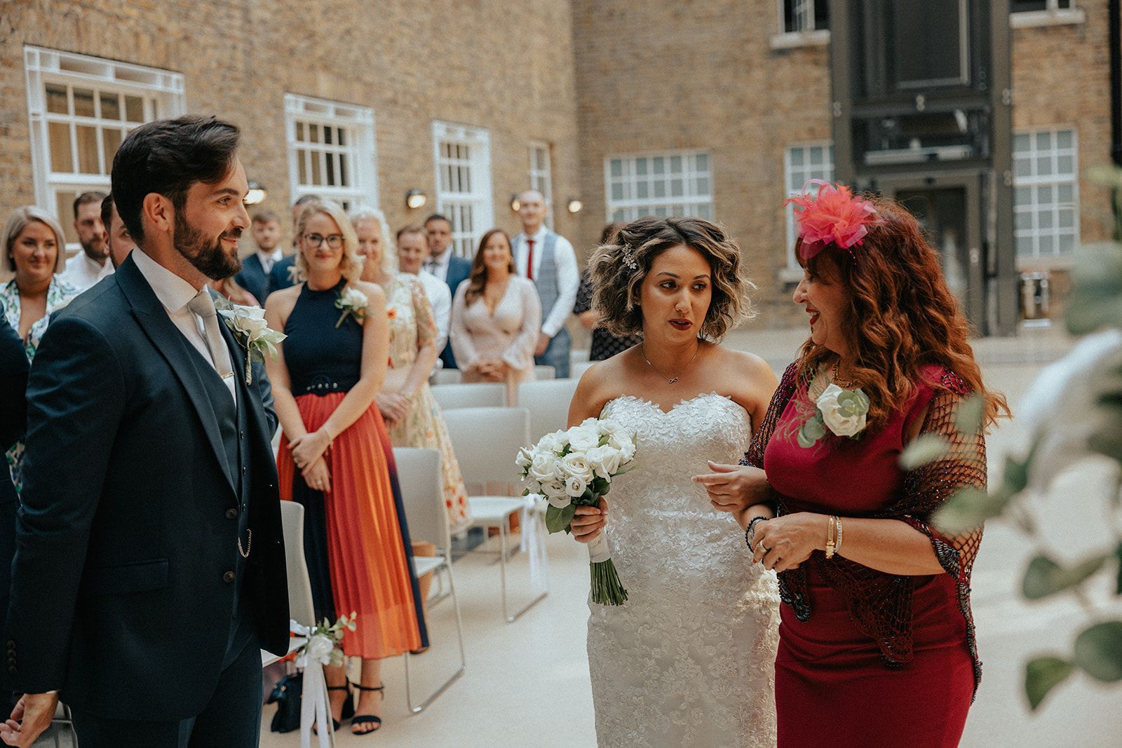 A bride and groom are walking down the aisle at their wedding ceremony.