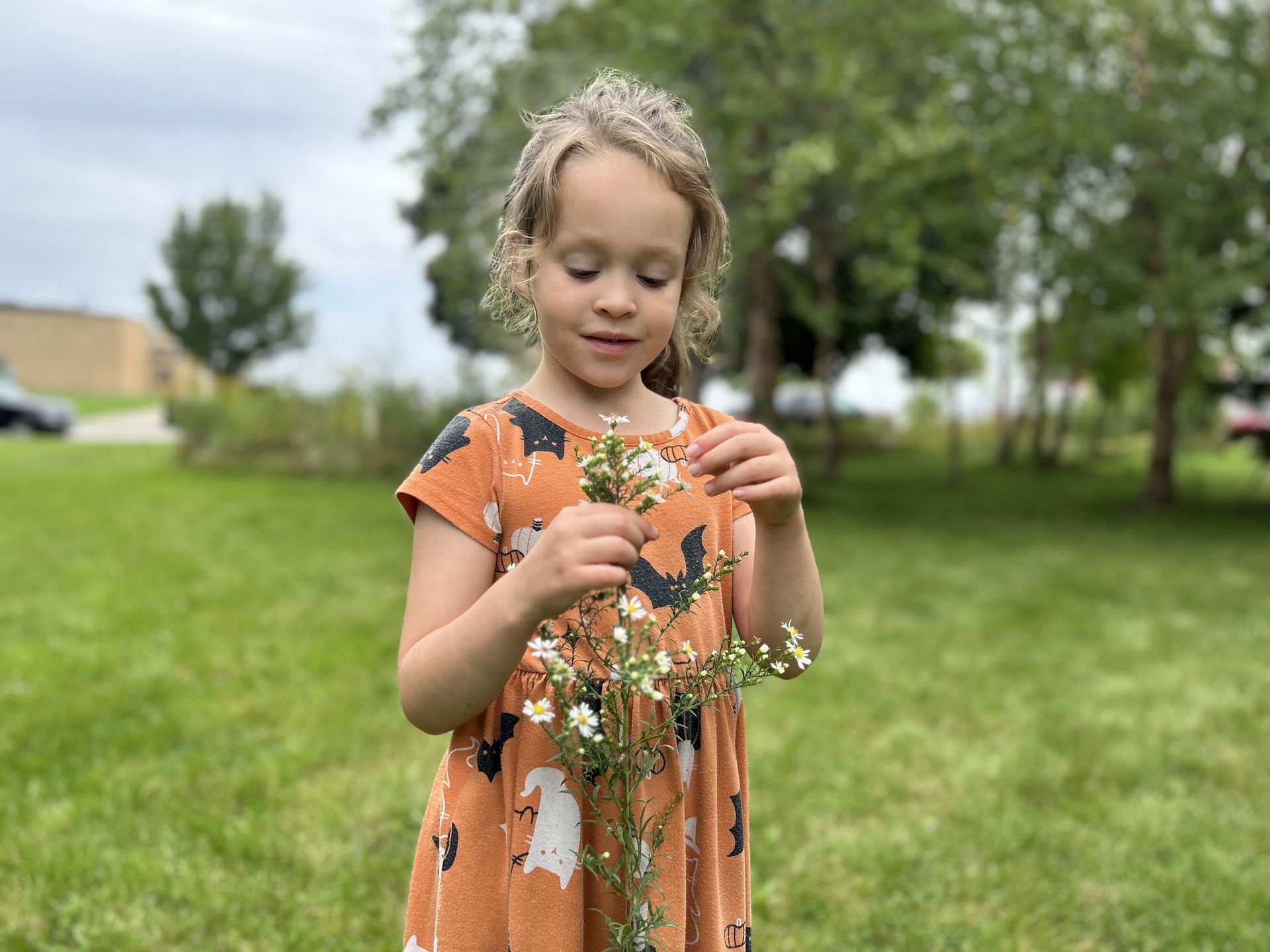 Montessori children holding a flower