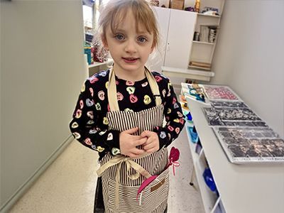 montessori child wearing apron