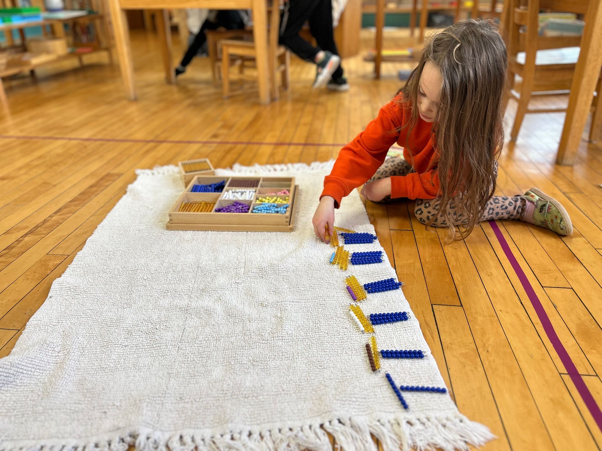 Montessori child working with beads materials