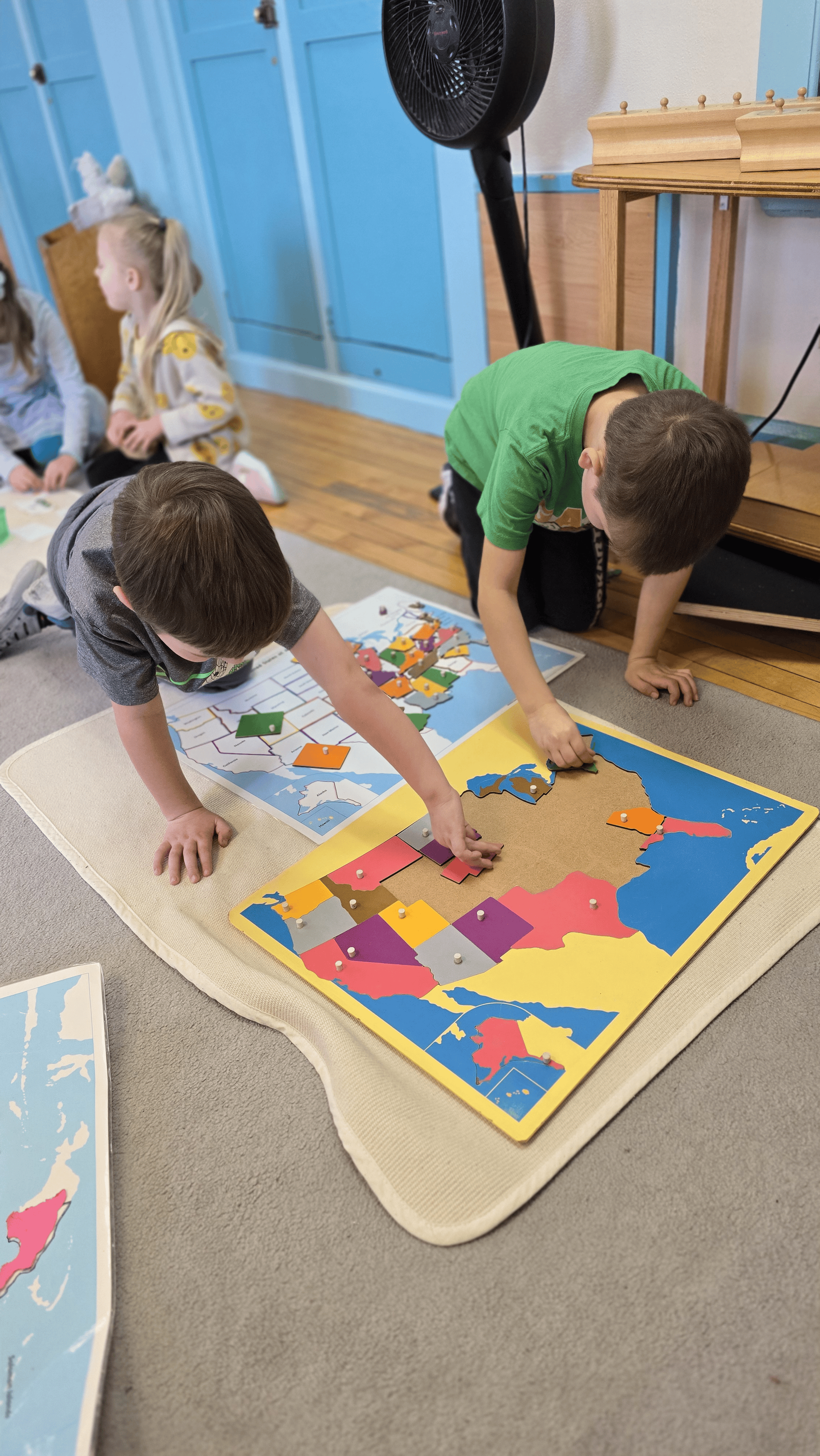 montessori child working with puzzle map