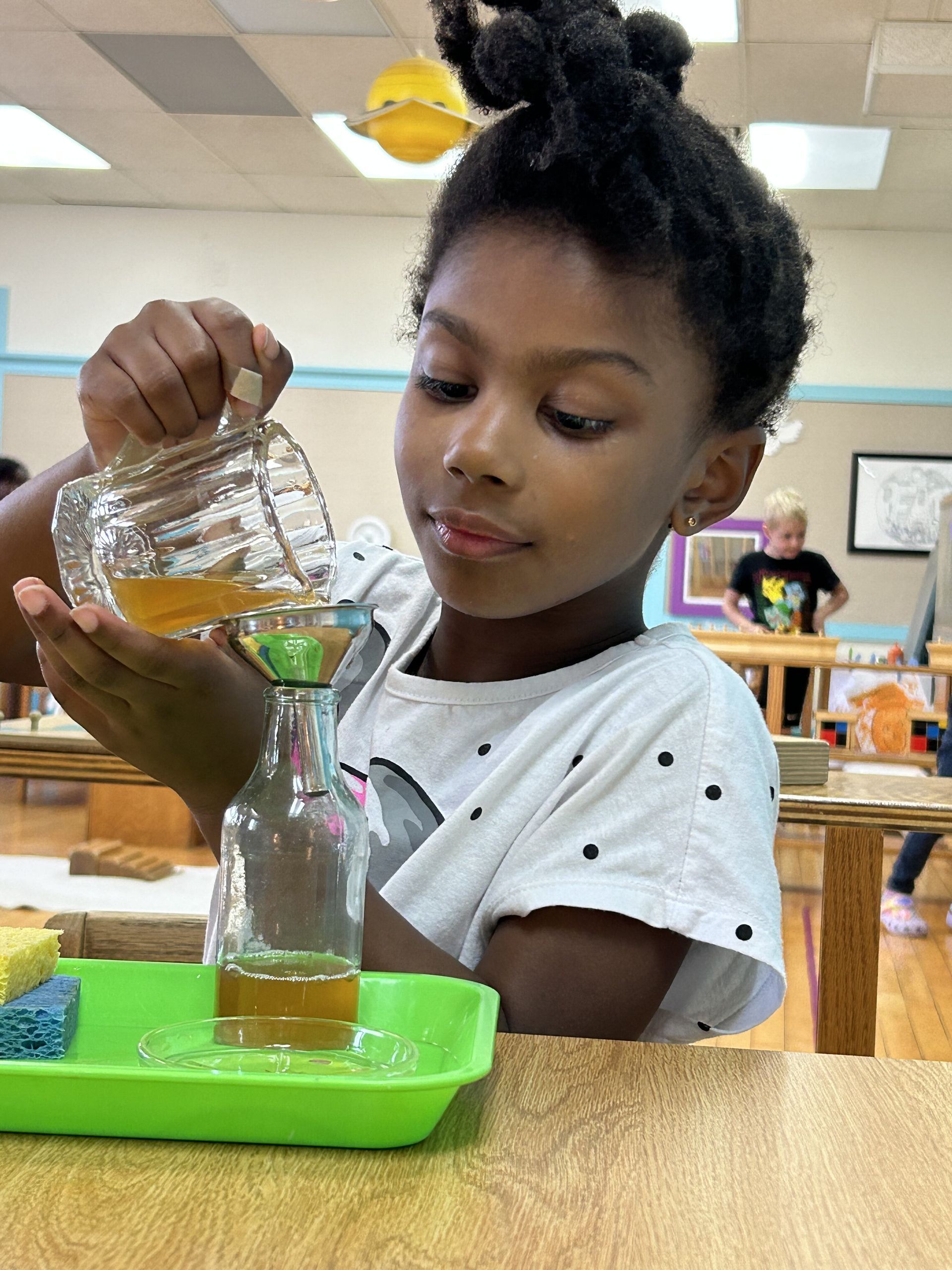 montessori child working with practical life activity