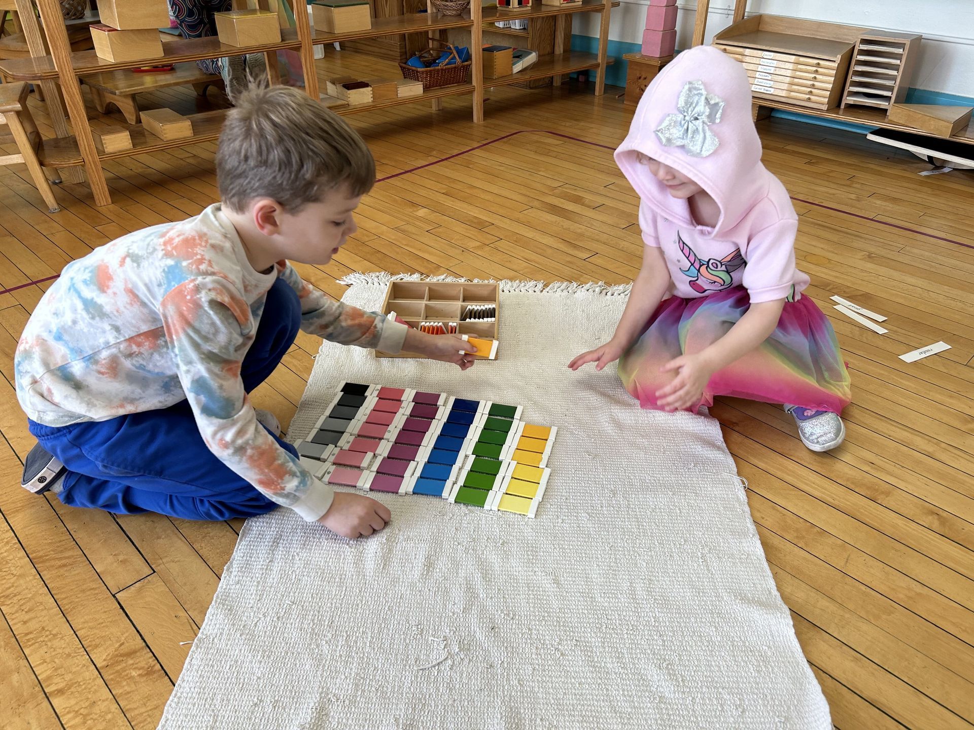 Montessori children working with sensorial materials