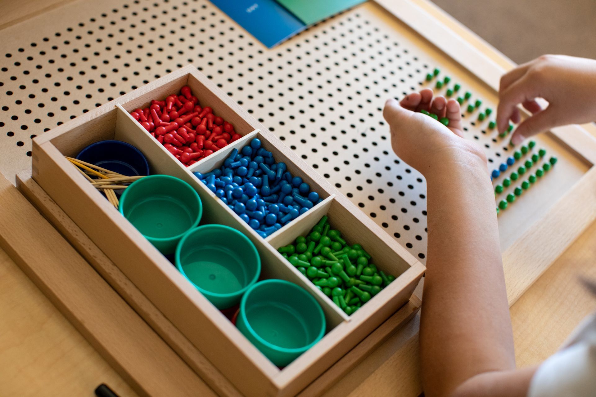 Montessori child working with the square root peg board