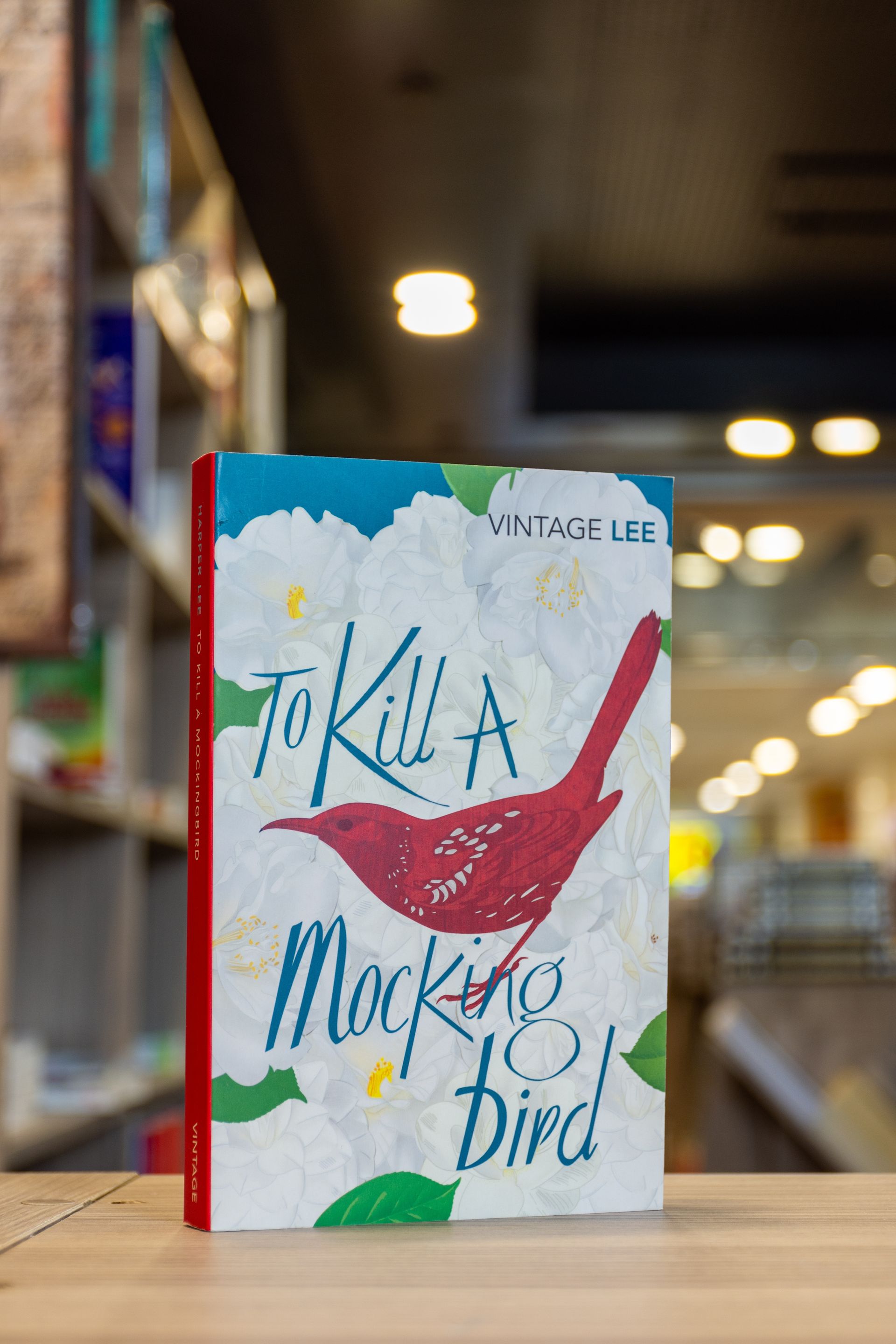 Book cover with a red cardinal and the title “To Kill a Mockingbird” on a table.