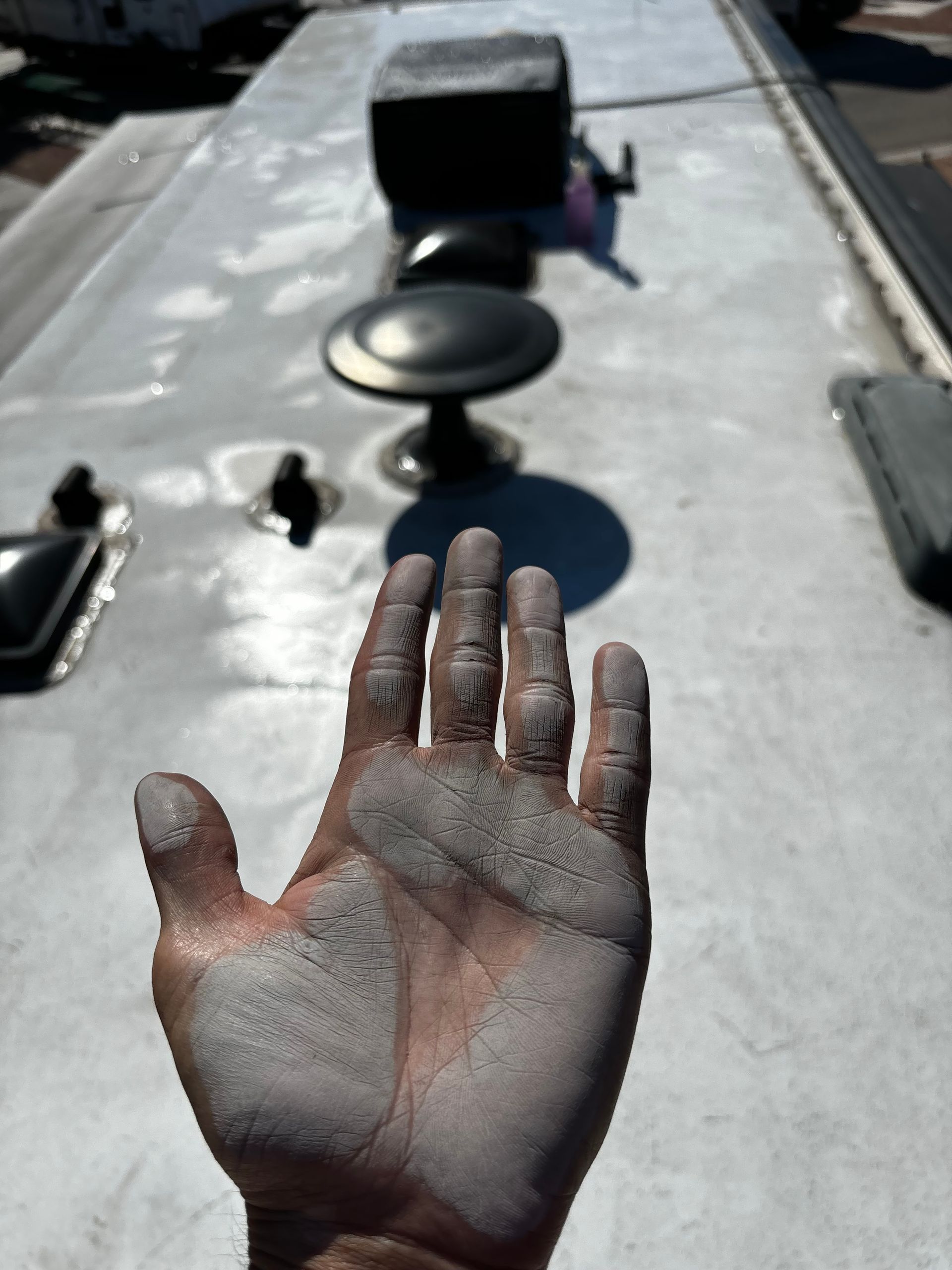 A person 's hand with a lot of dust on it