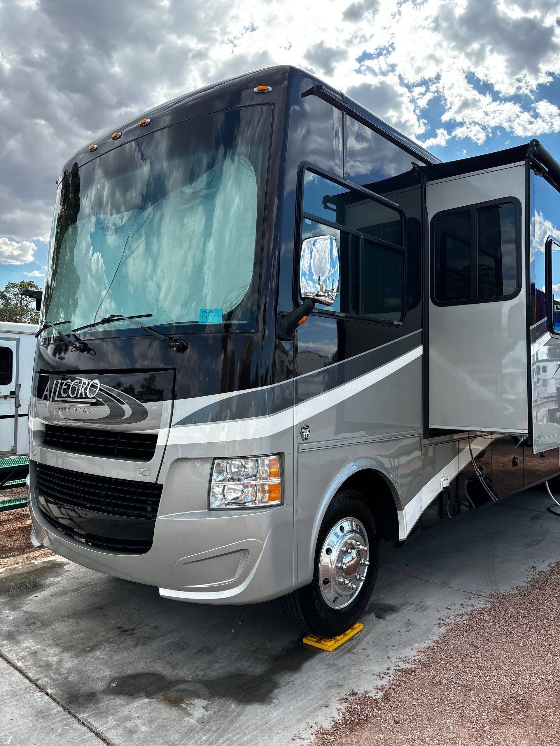 A large rv is parked on the side of the road.