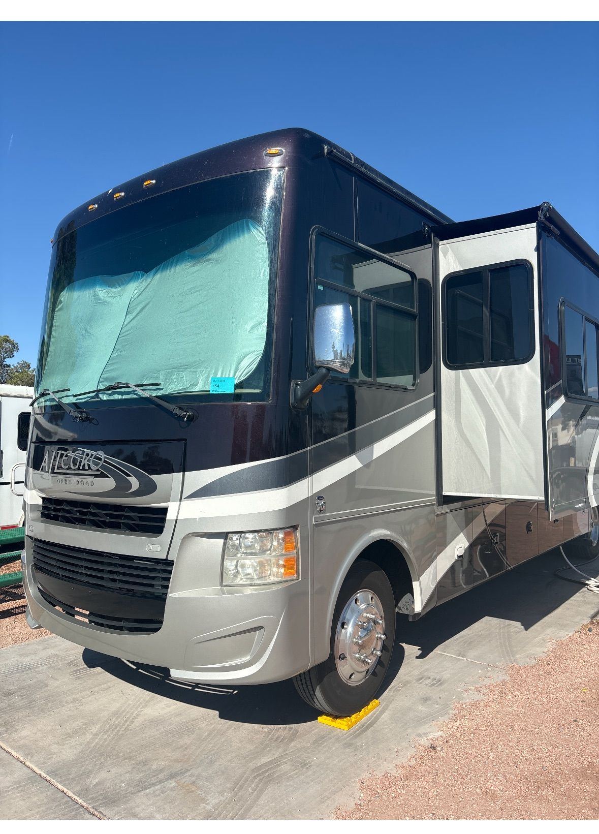 A large rv is parked on the side of the road.