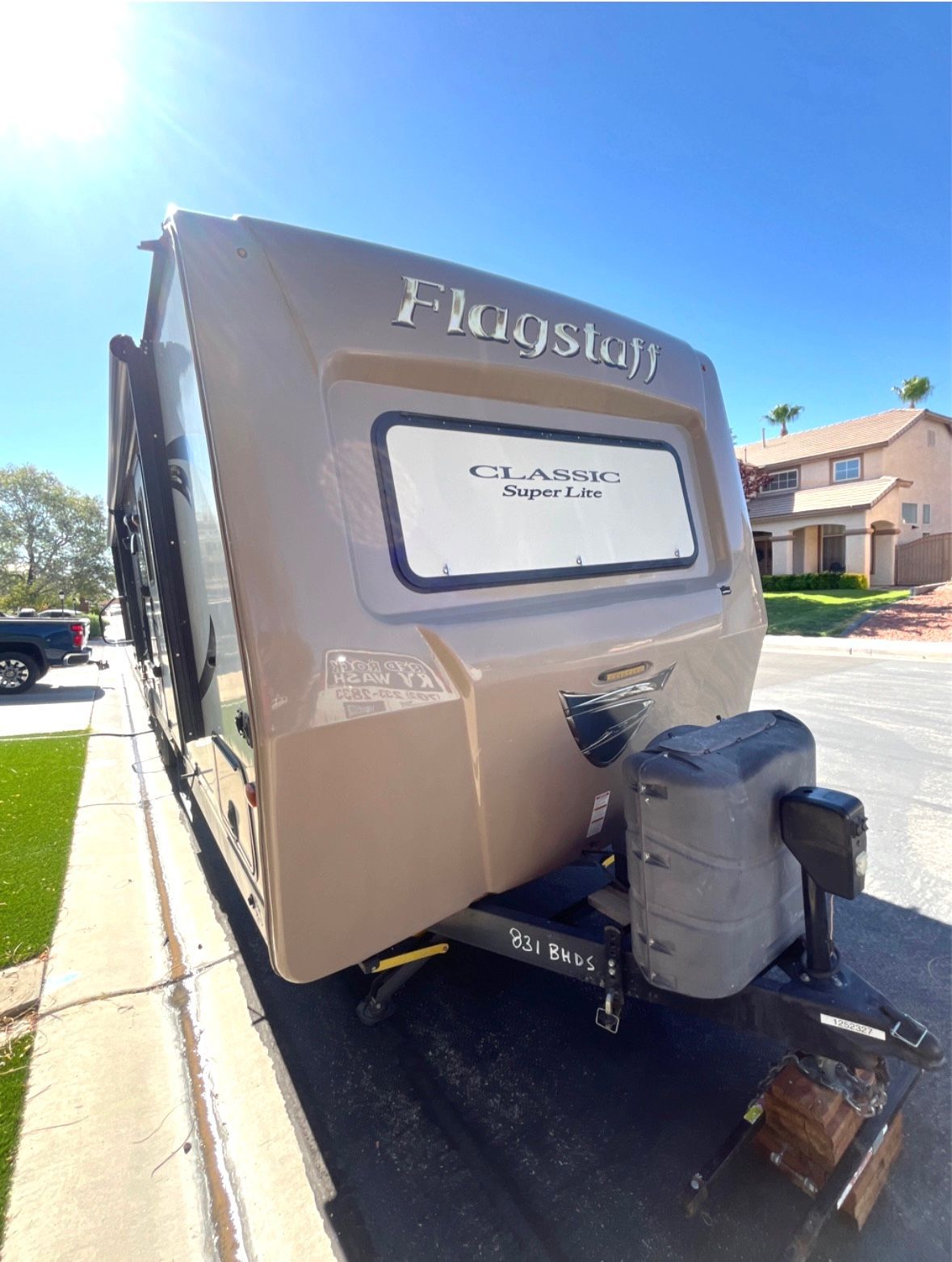 A rv is parked on the side of the road.