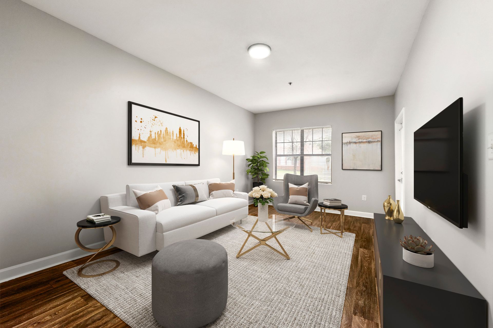 Modern living room with white sofa, gray chair, wall-mounted TV, and neutral decor
