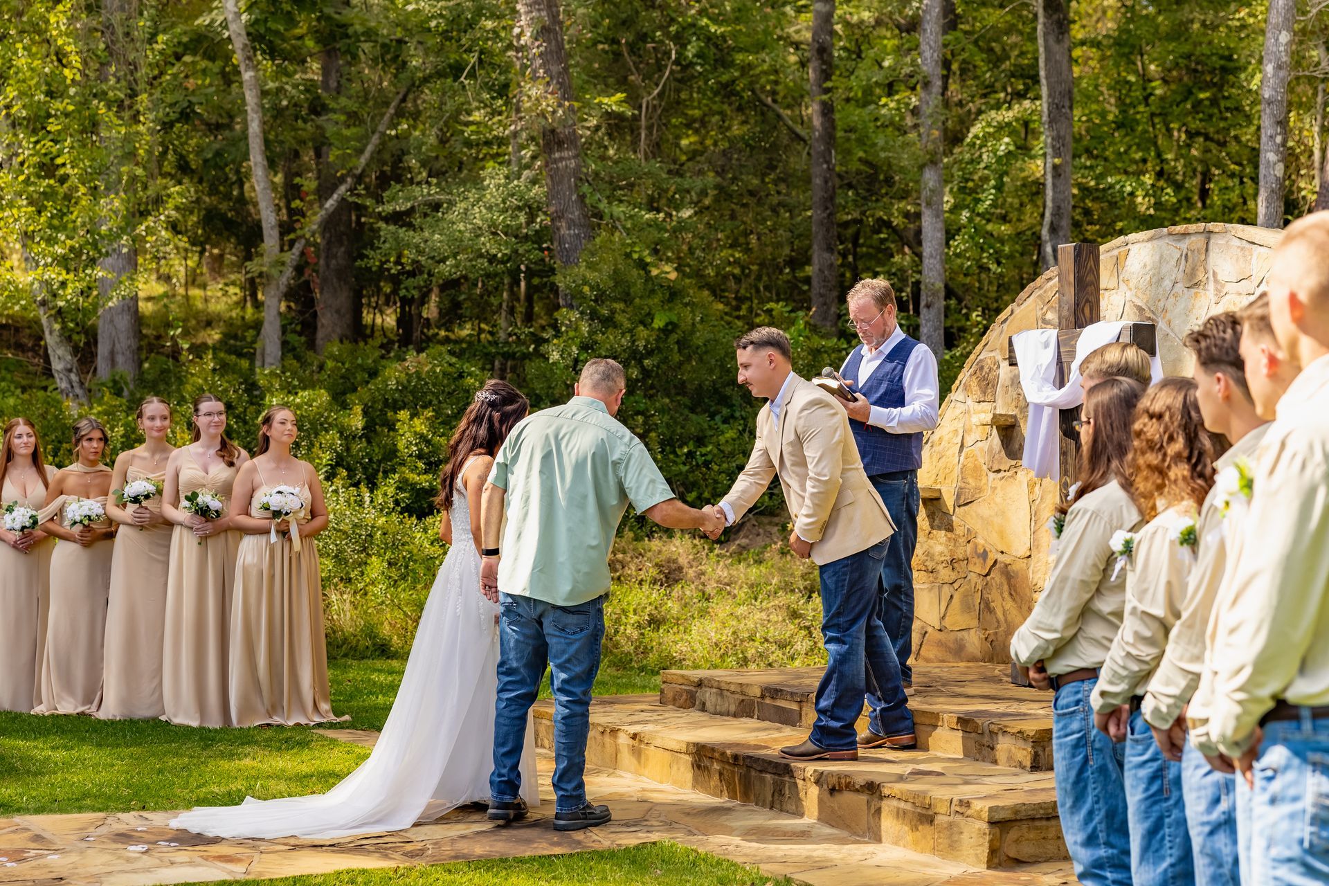 Kalico Creek Wedding Venue outdoor Ceremony candid photo of the father of the bride shaking grooms' hand at the alter