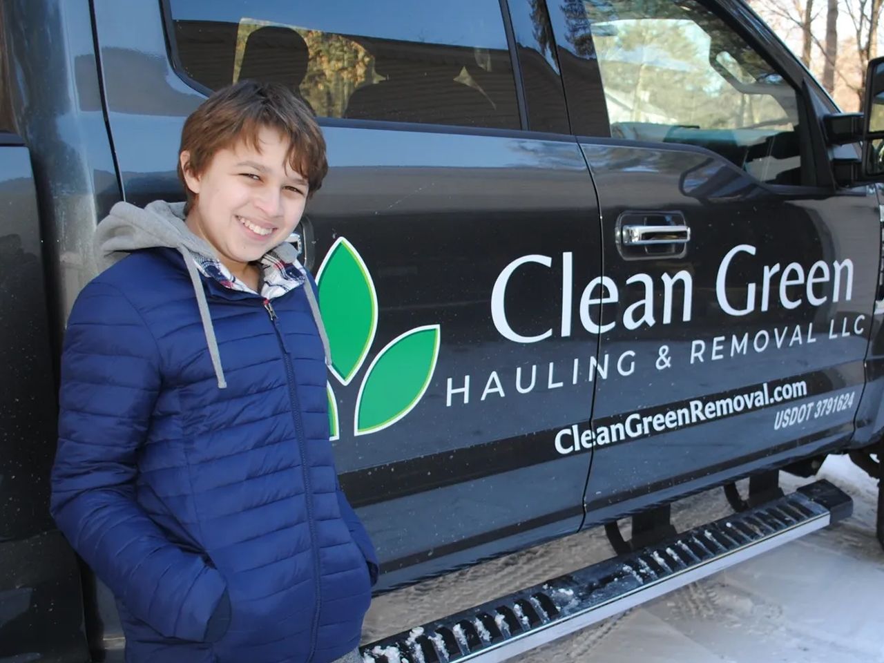 Family with Clean Green junk removal truck
