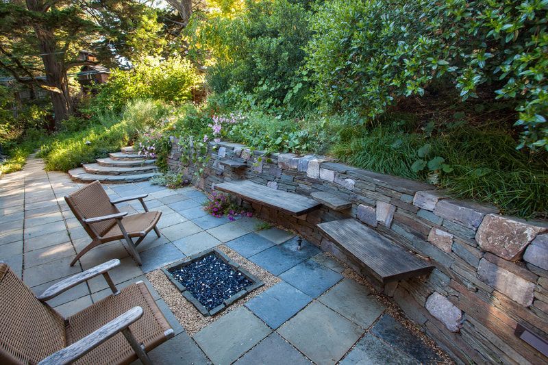 There is a fire pit in the middle of the patio.