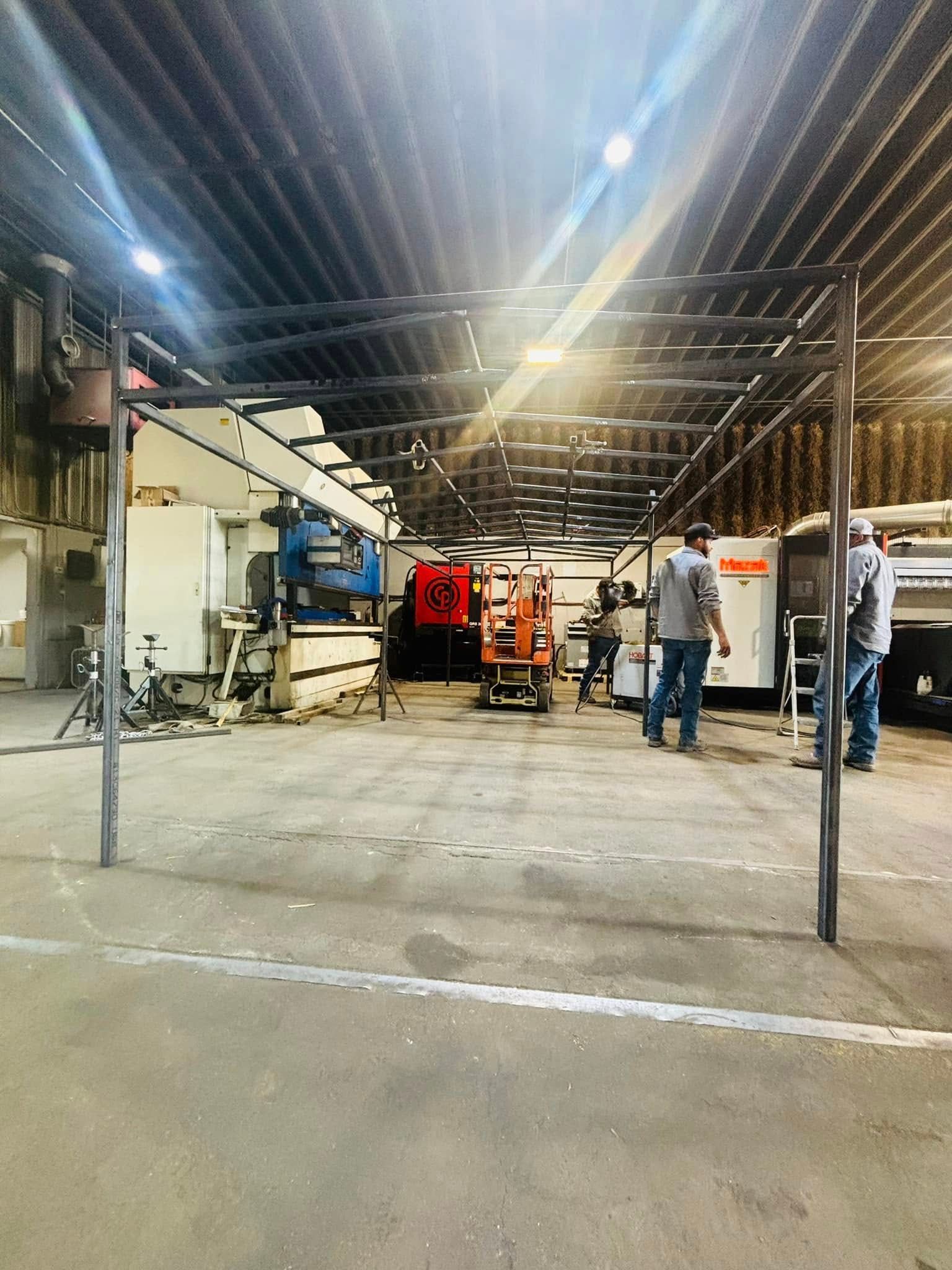 A group of people are standing in a large warehouse.