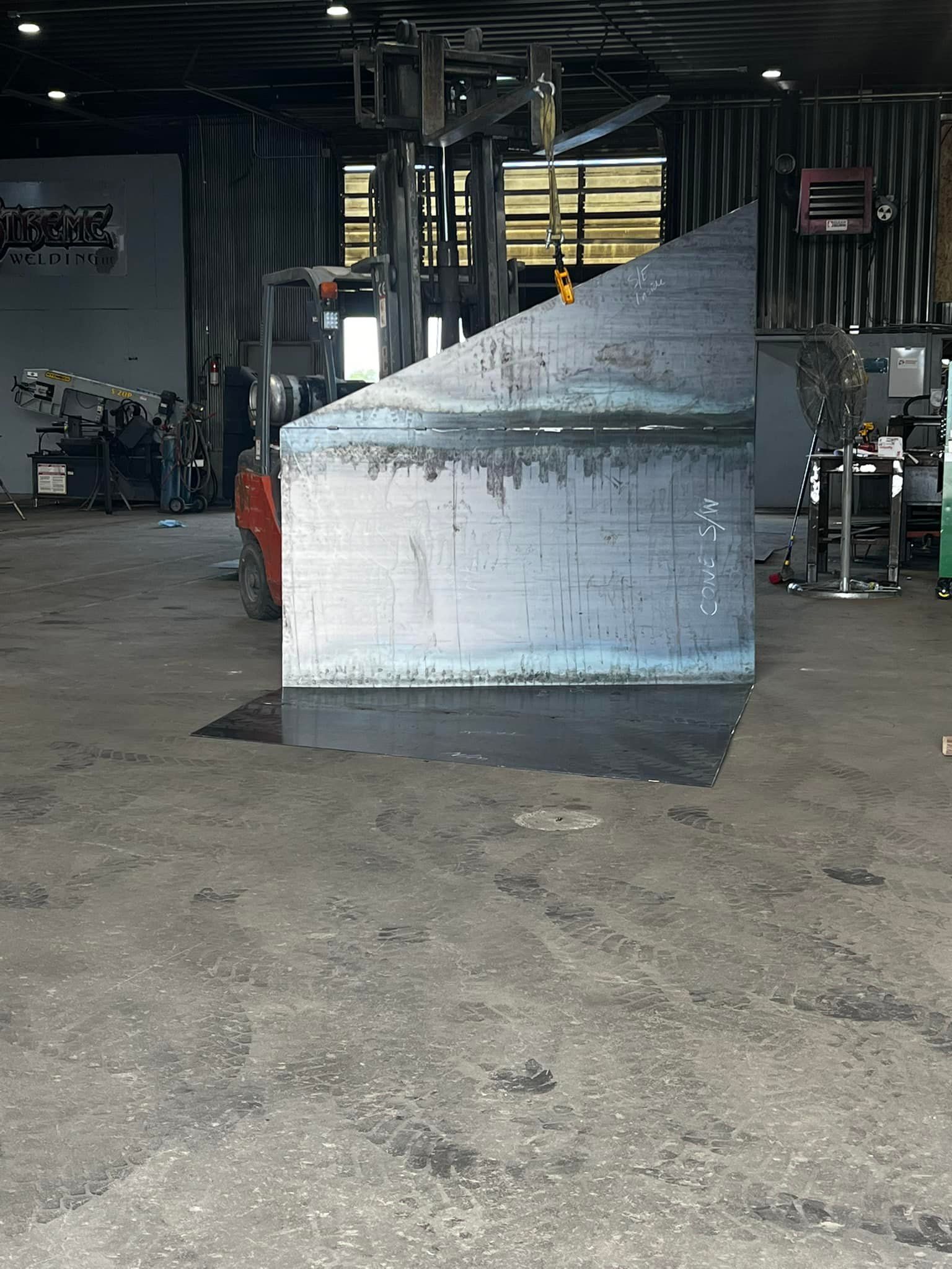 A large brick wall is sitting in the middle of a warehouse.