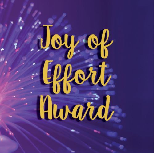 Joy of Effort Award text in gold on a purple fireworks-style background
