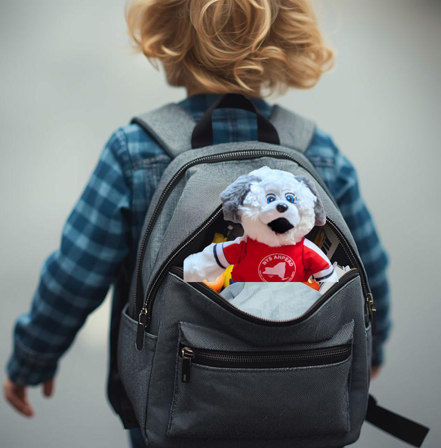 Child with gray backpack showing a stuffed dog in the front pocket