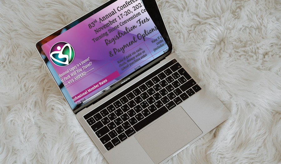Open laptop on a white fur surface, showing a purple presentation slide on screen.