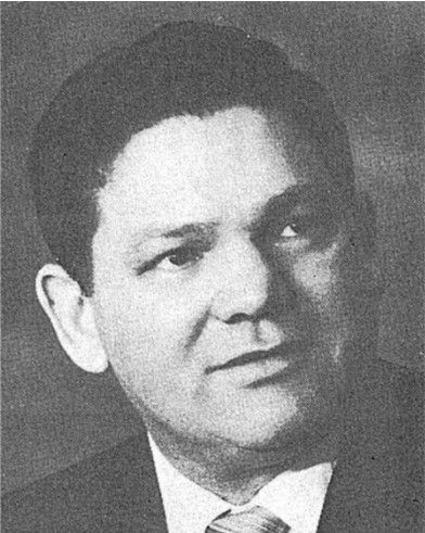 Black-and-white portrait of a man in a suit, facing slightly right with a neutral expression