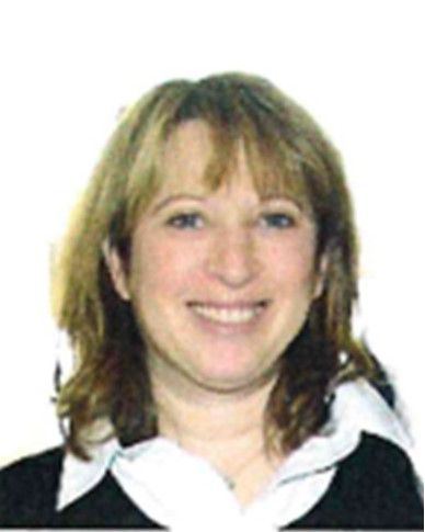 Smiling woman with shoulder-length light brown hair, wearing a black-and-white top against a white background