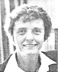 Smiling person in a collared shirt, photographed in black and white.