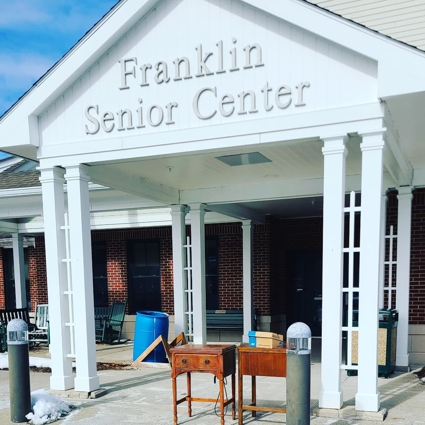 The franklin senior center has a white awning over the entrance