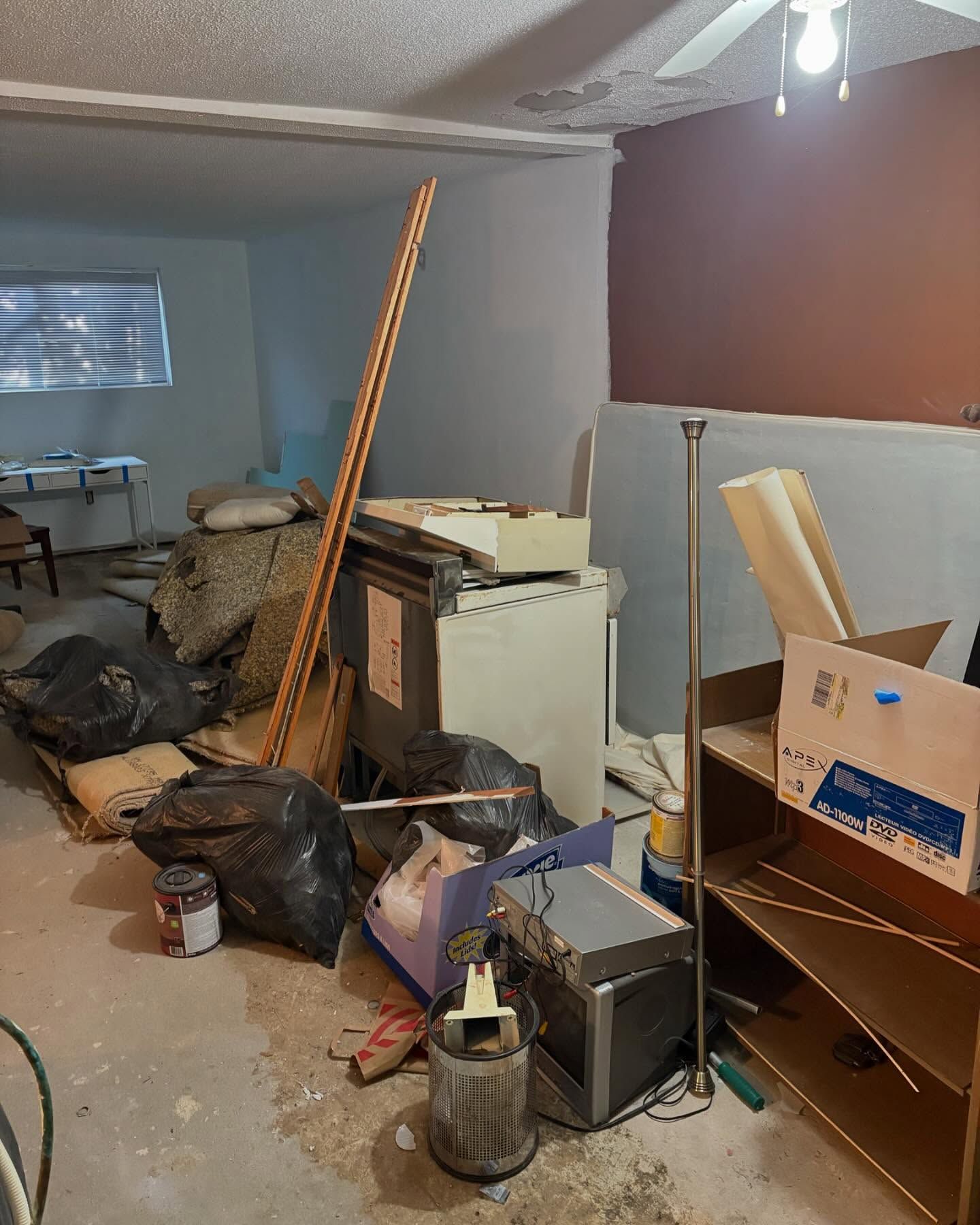 A room with a lot of trash and boxes on the floor