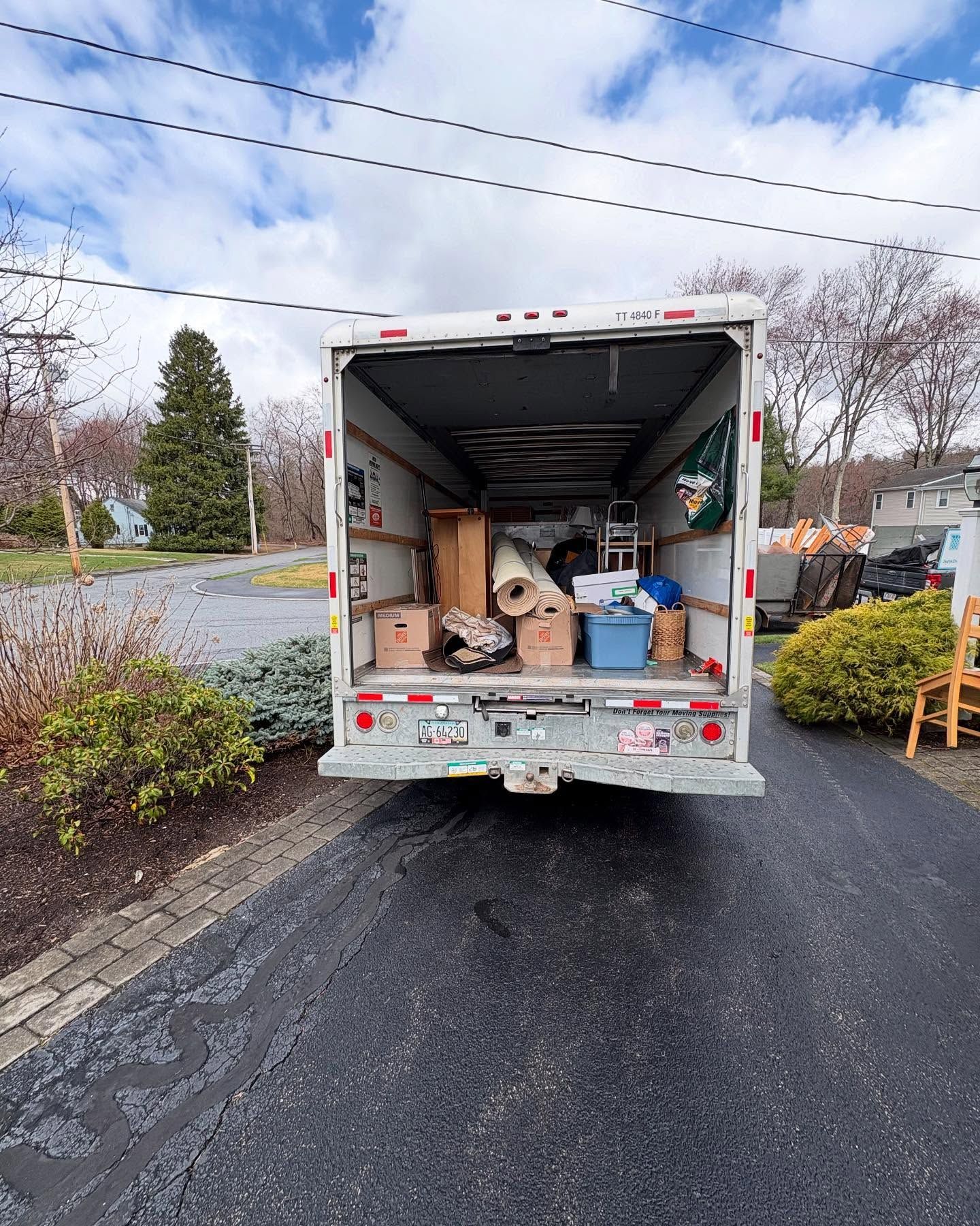 A moving truck is filled with furniture and boxes.