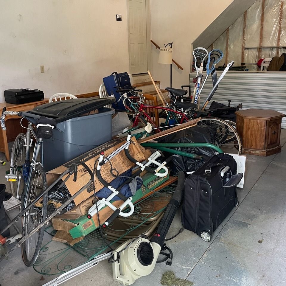 A garage filled with lots of junk including a bicycle
