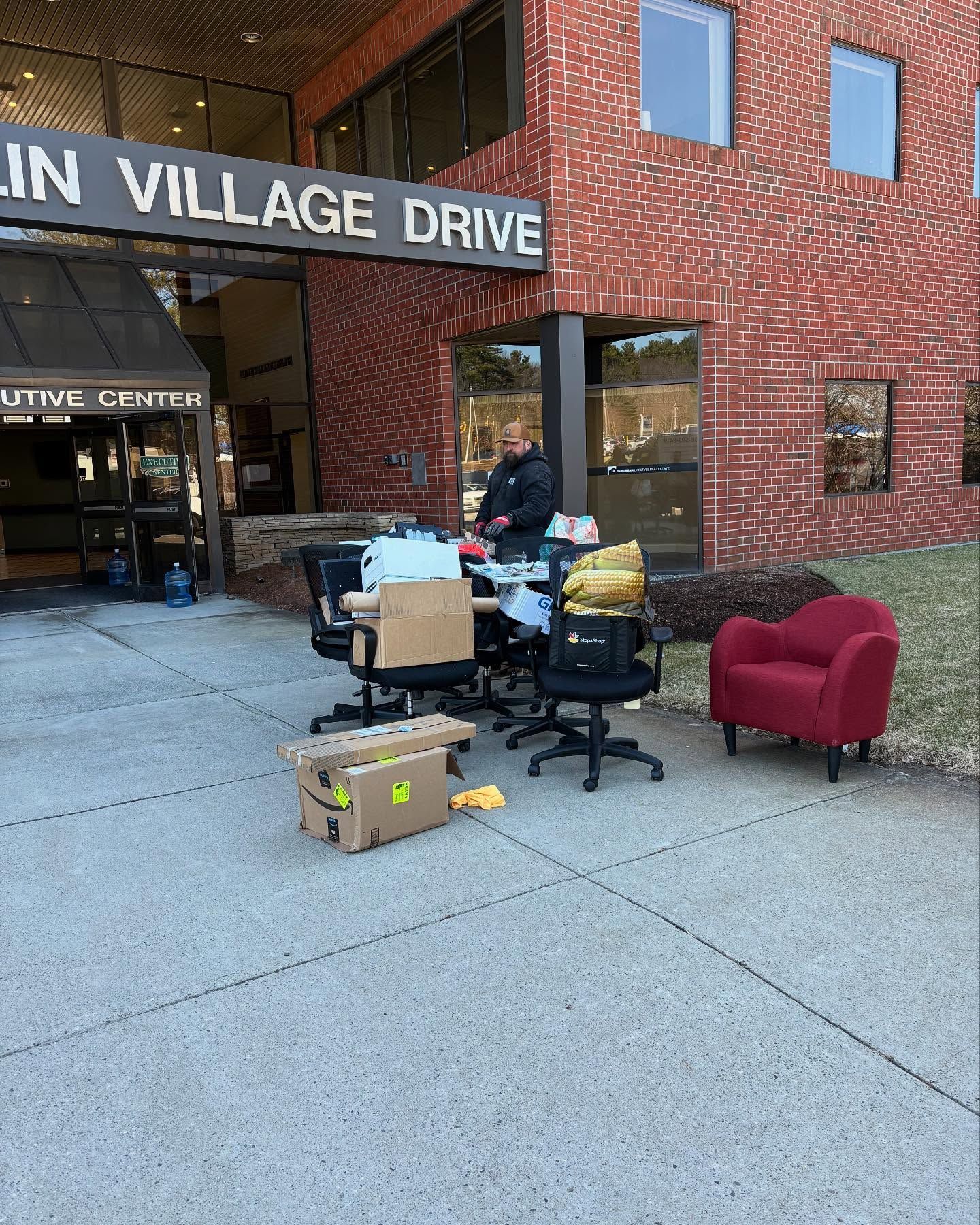 A brick building with a sign that says ' lin village drive ' on it