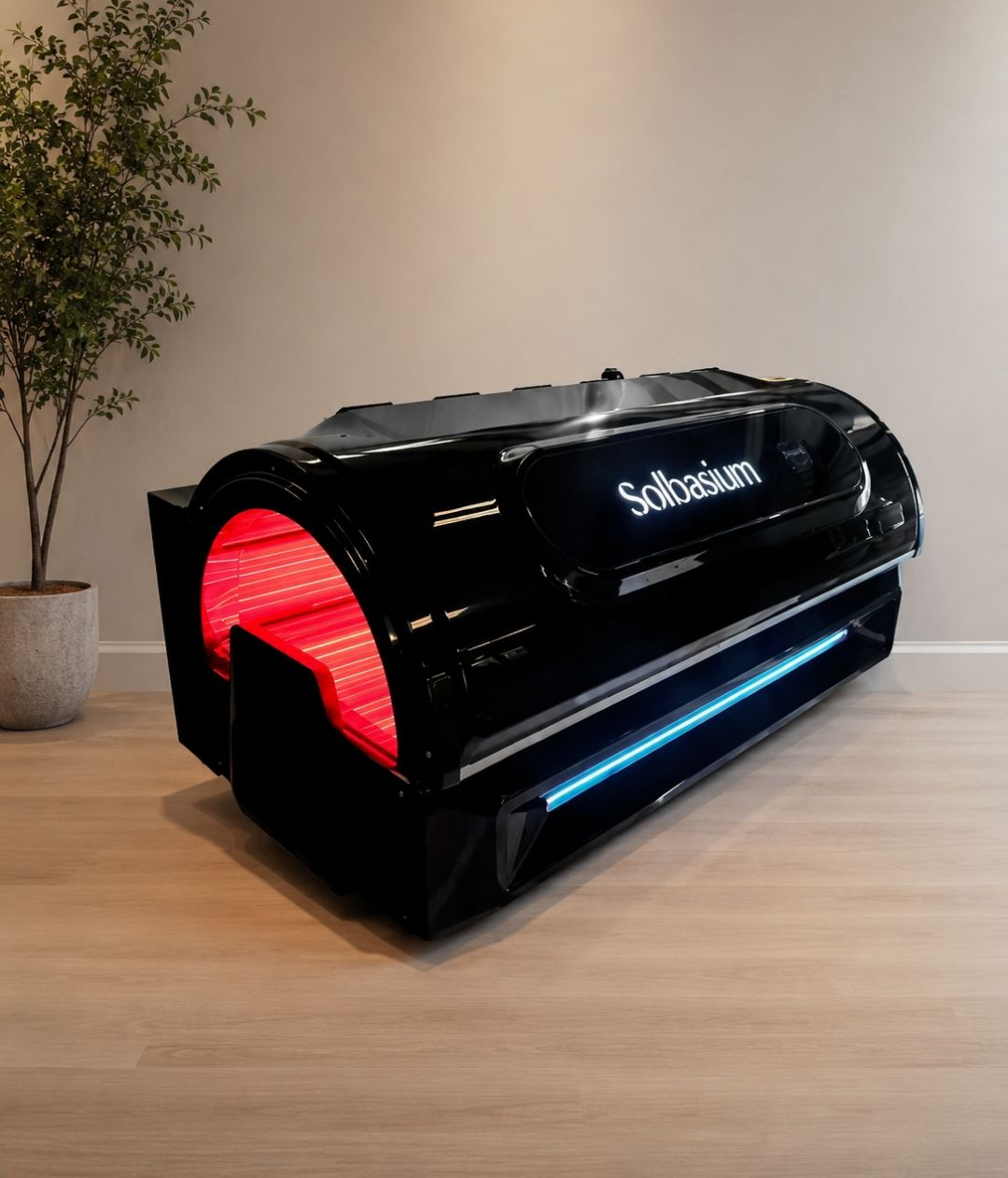 Person lying under red light therapy panel with a blanket over the body