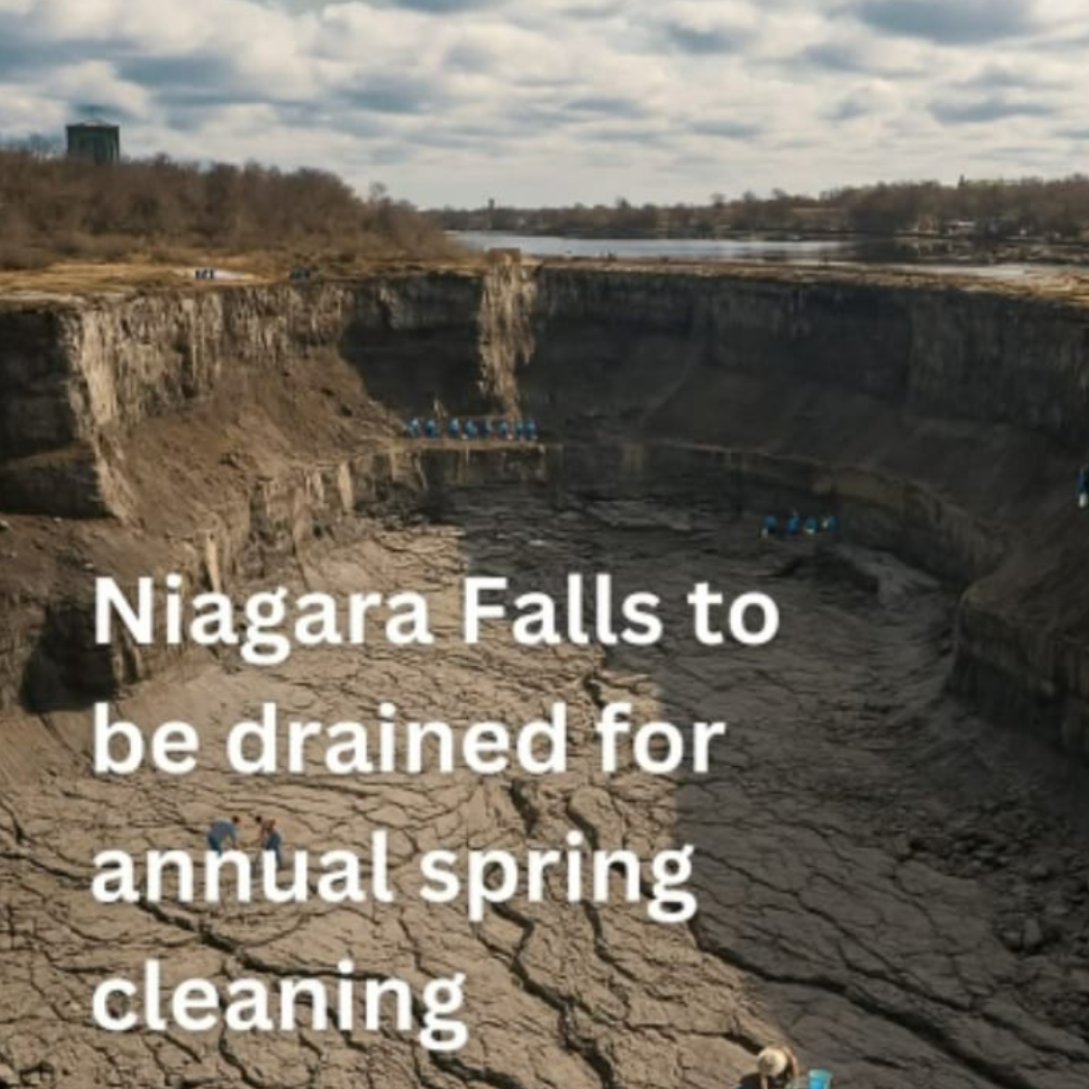 An empty, dried-up Niagara Falls riverbed with people walking on the rocky ground, captioned