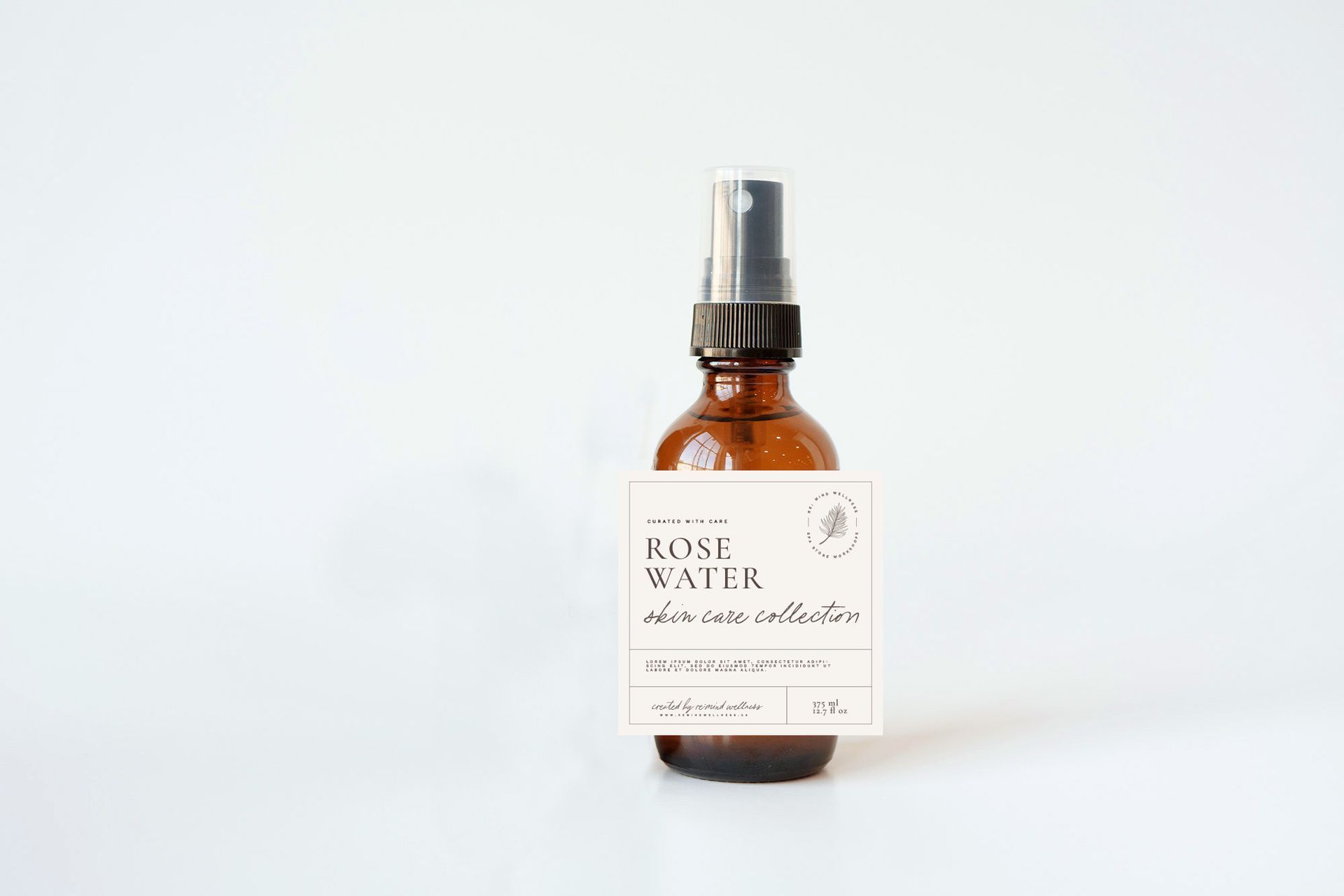 A bottle of rose water is sitting on a white surface.