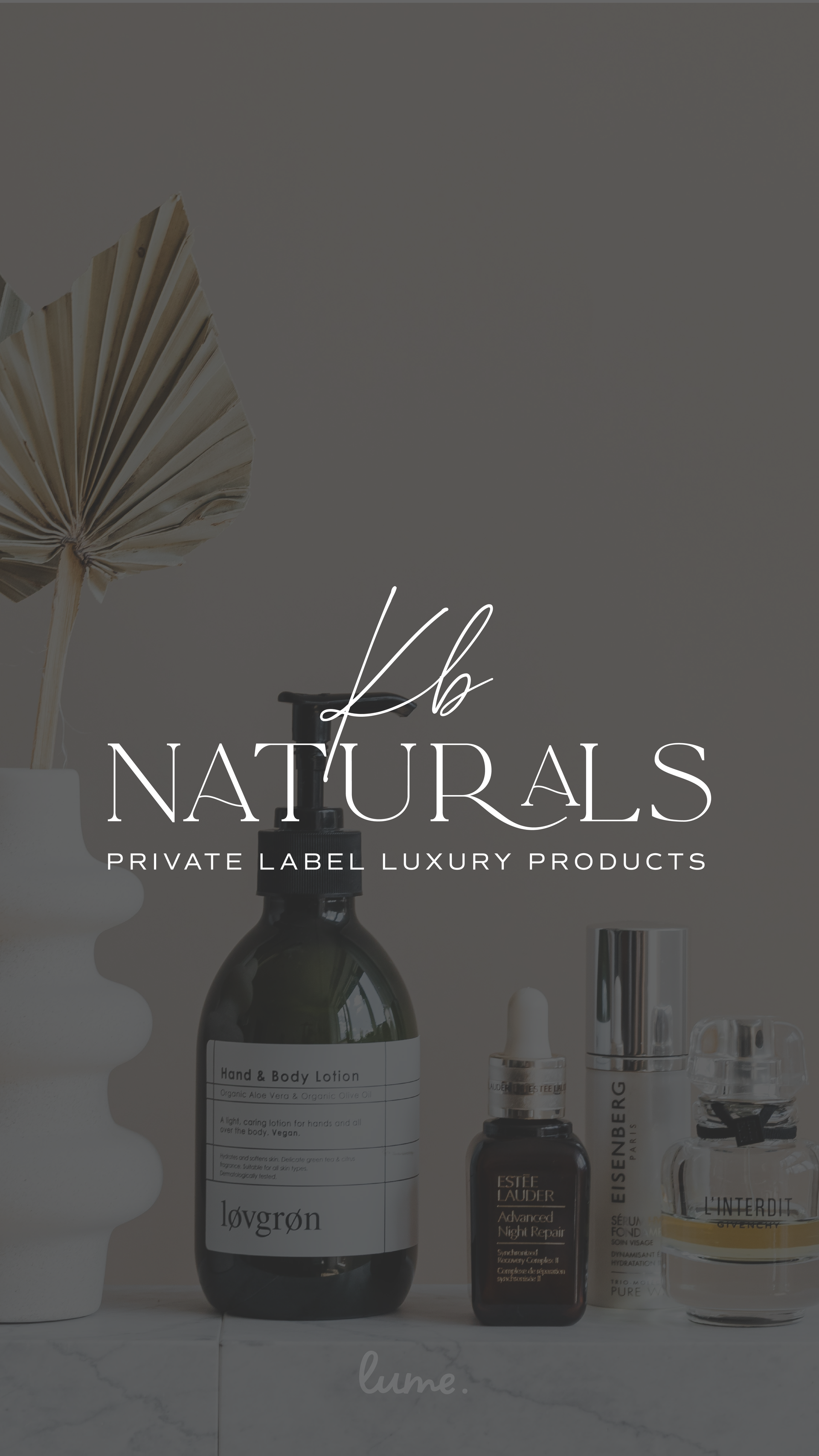 A bottle of lotion is sitting on a table next to a vase of flowers.