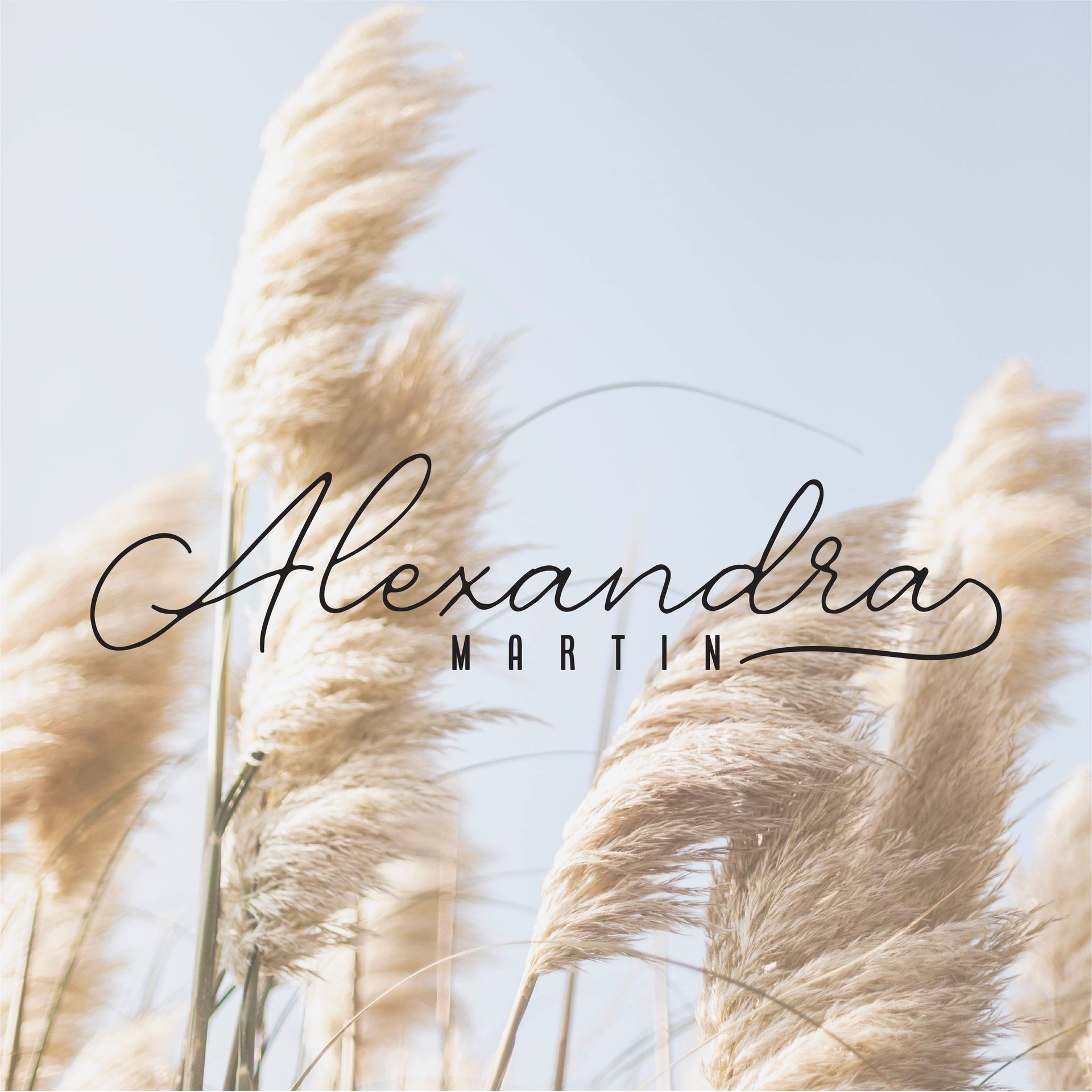 A logo for alexandra martin with tall grass in the background