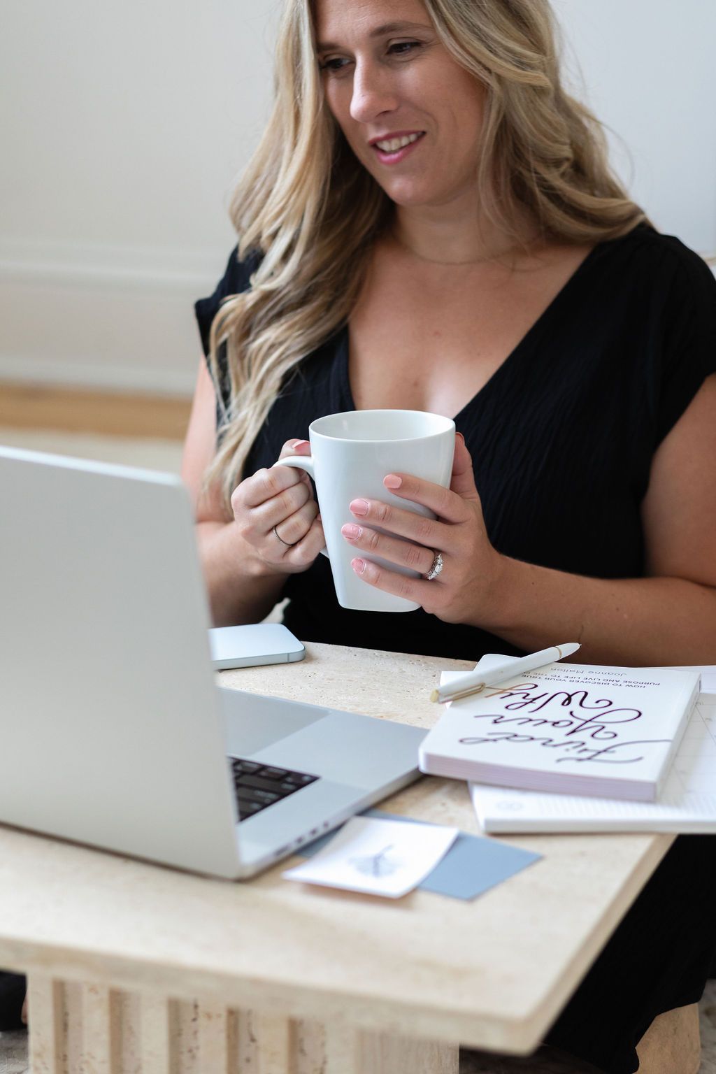 Kerri of Lume Creative, a web design studio in London Ontario, in a bright workspace