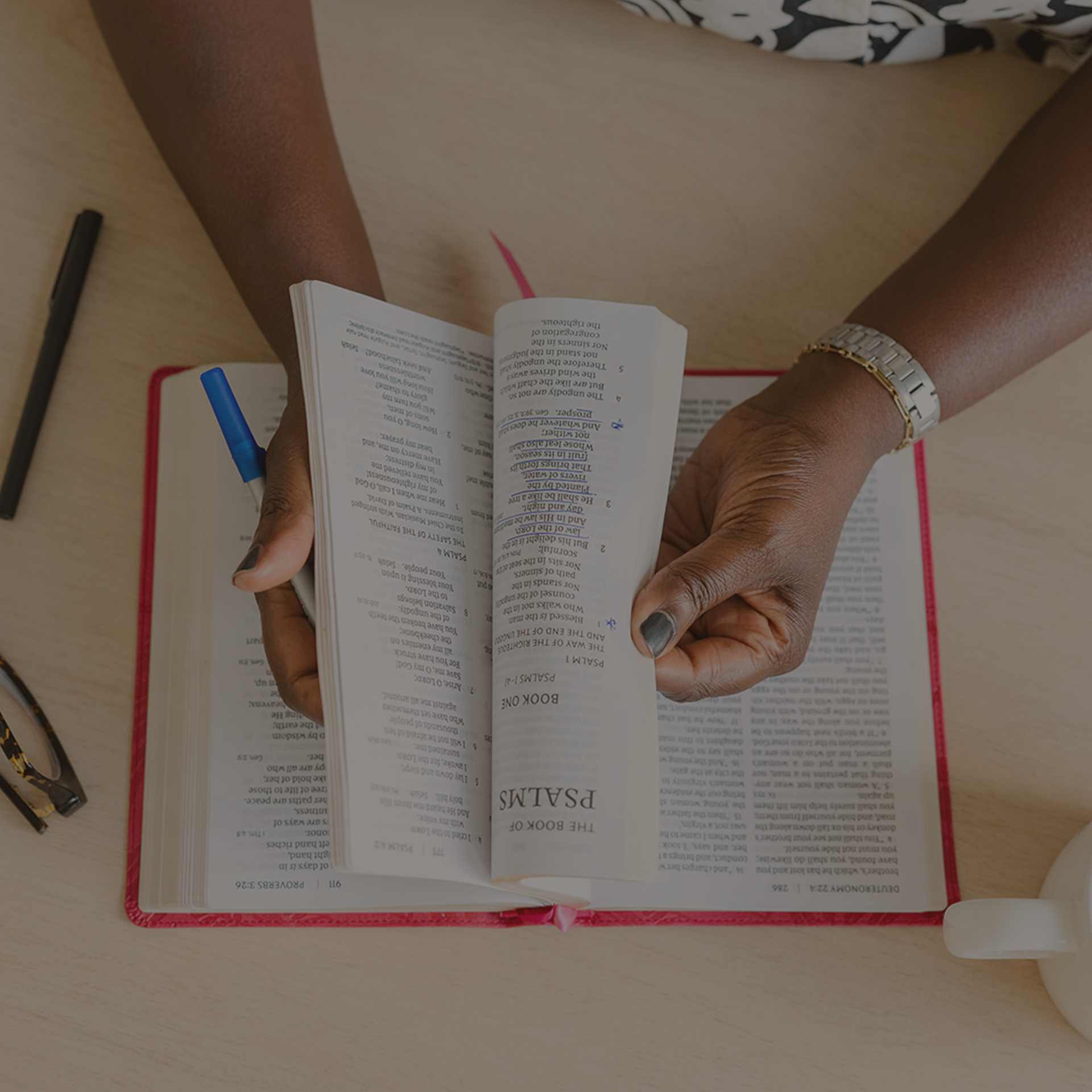 Hands opening a bible.