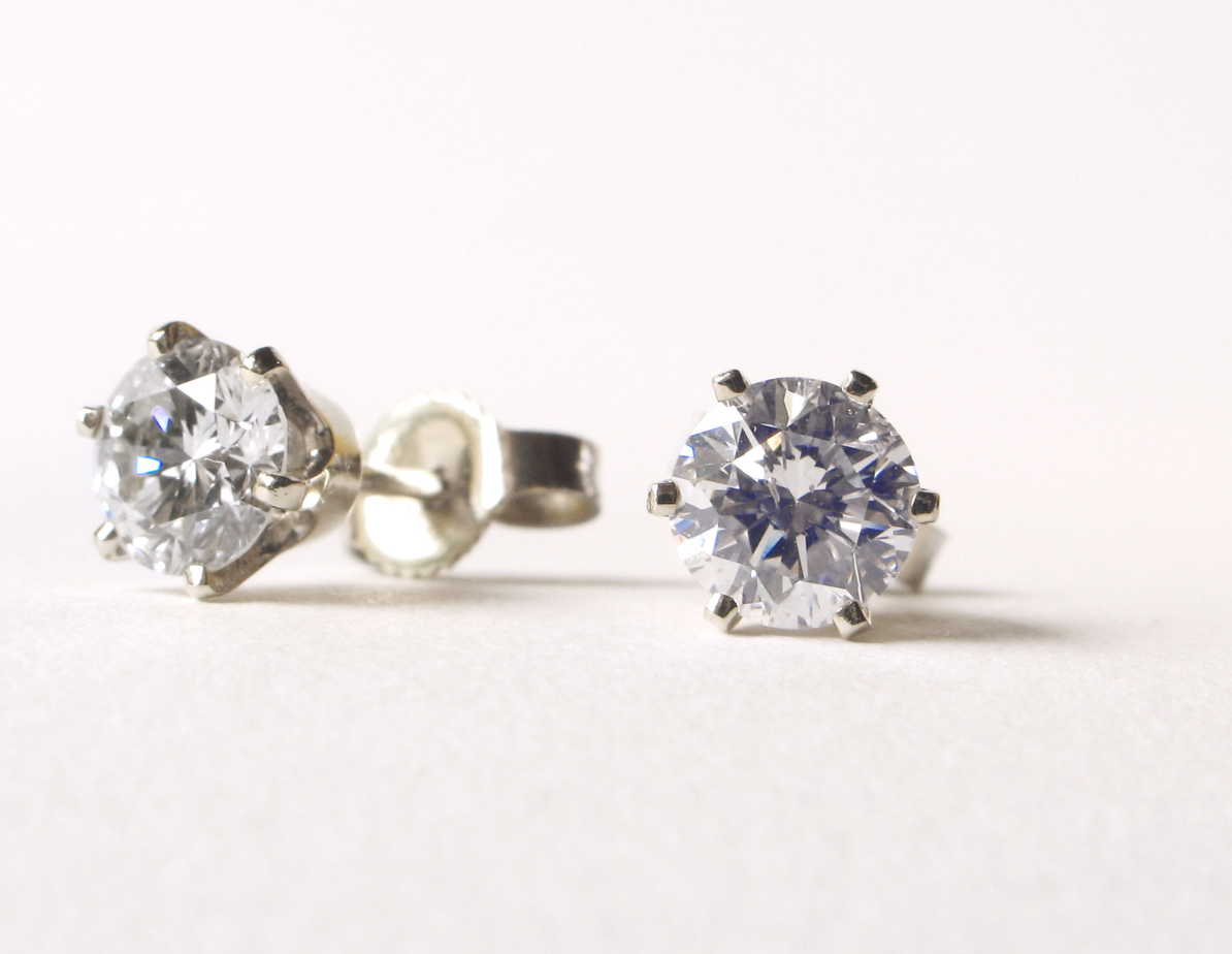 Pair of diamond stud earrings on a white background