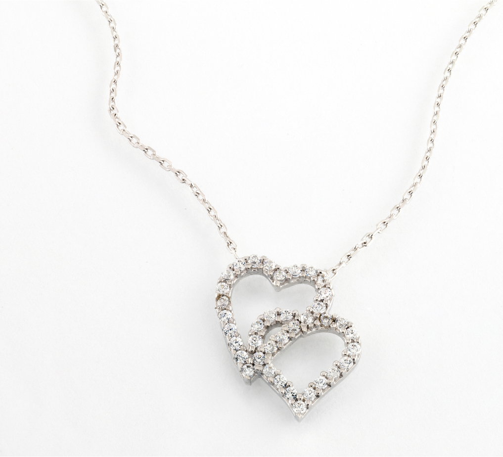 Silver heart-shaped pendant necklace on a white background