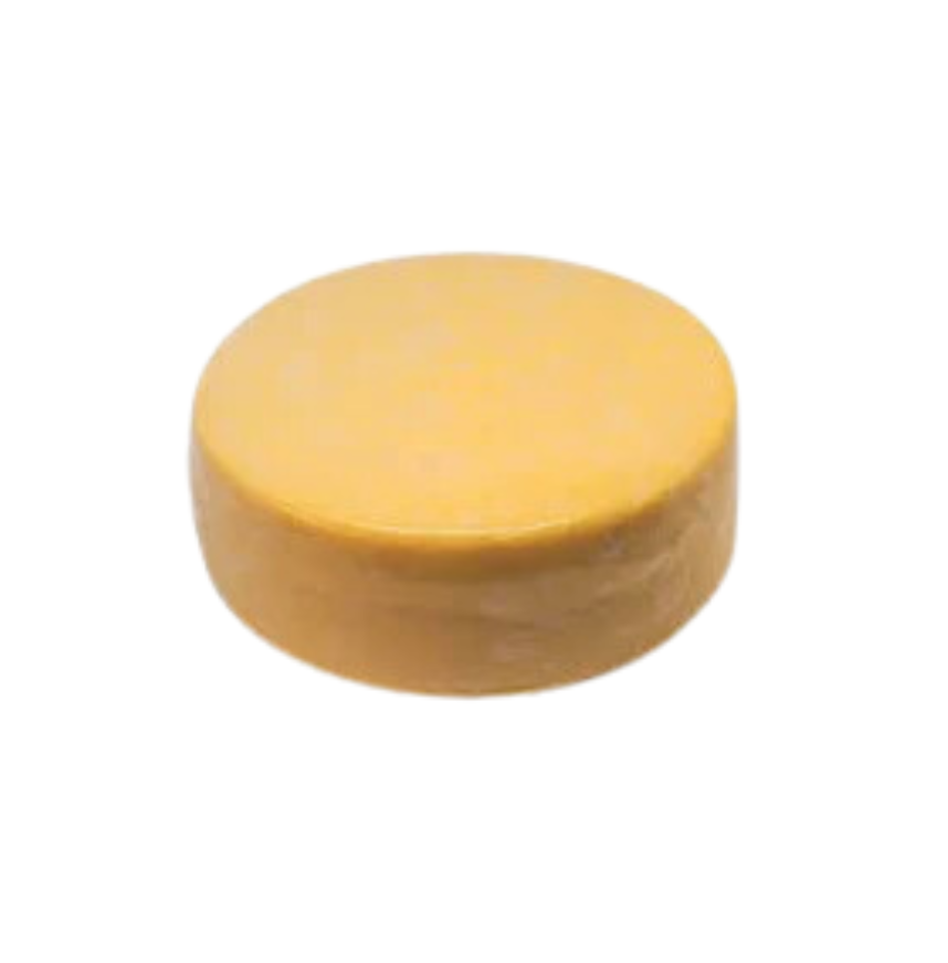 A whole cheese wheel showcasing traditional dairy craftsmanship as part of milk products.