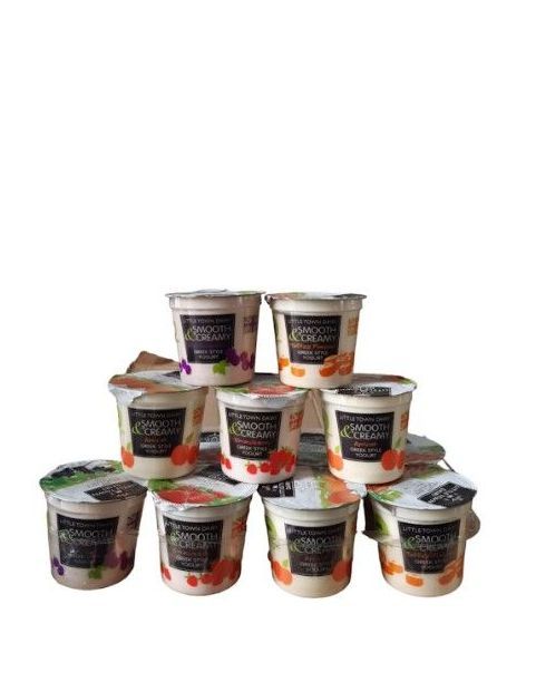 A stack of dairy yoghurt containers in different flavours and varieties.