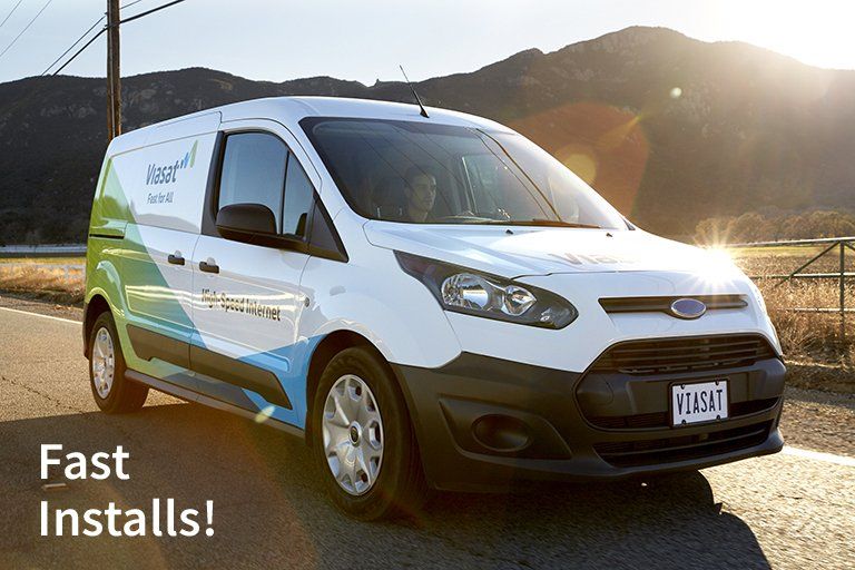 White Ford van with company logo parked on road, mountains in background, text reads 